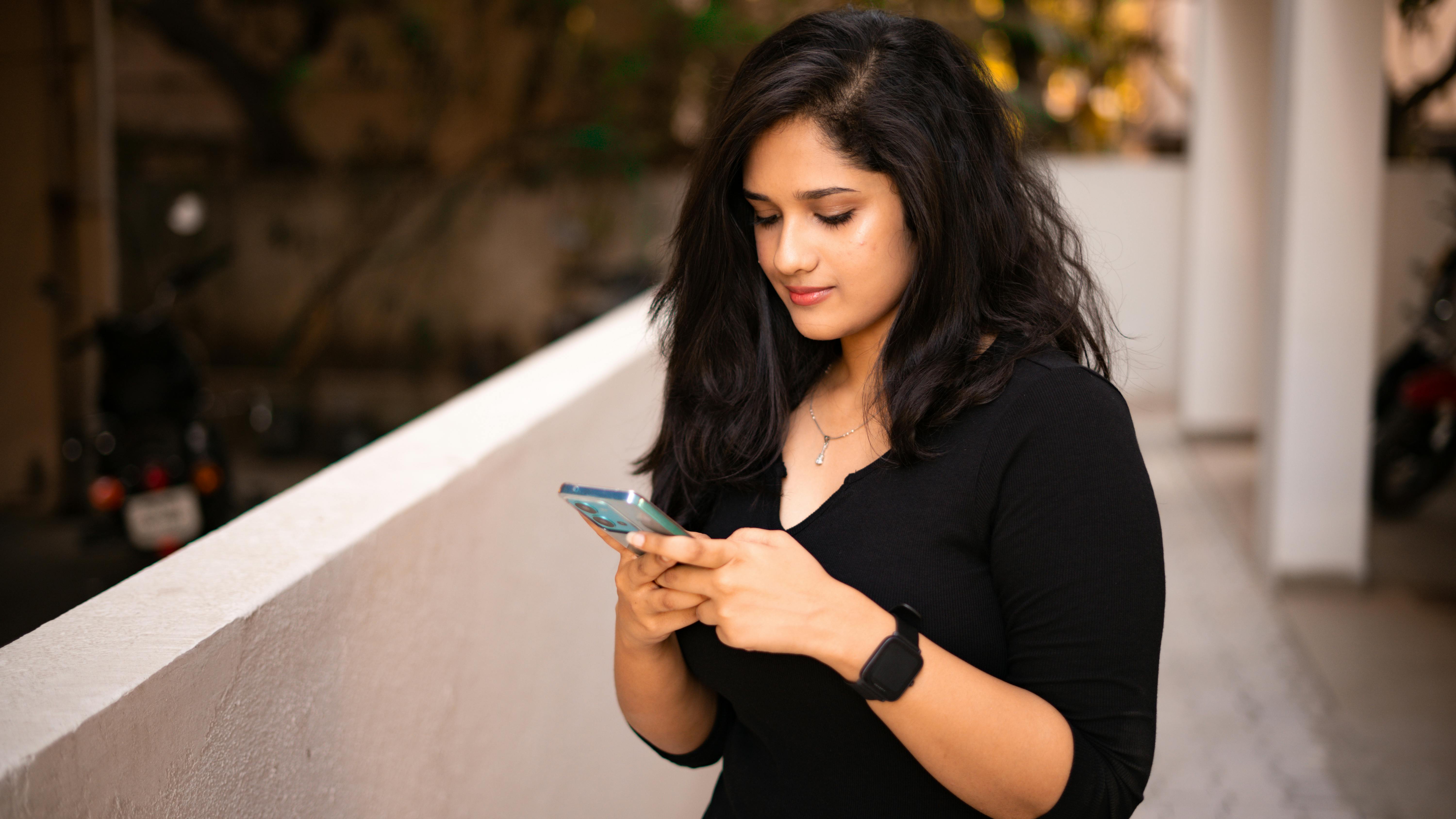 A woman looking at her phone | Source: Pexels