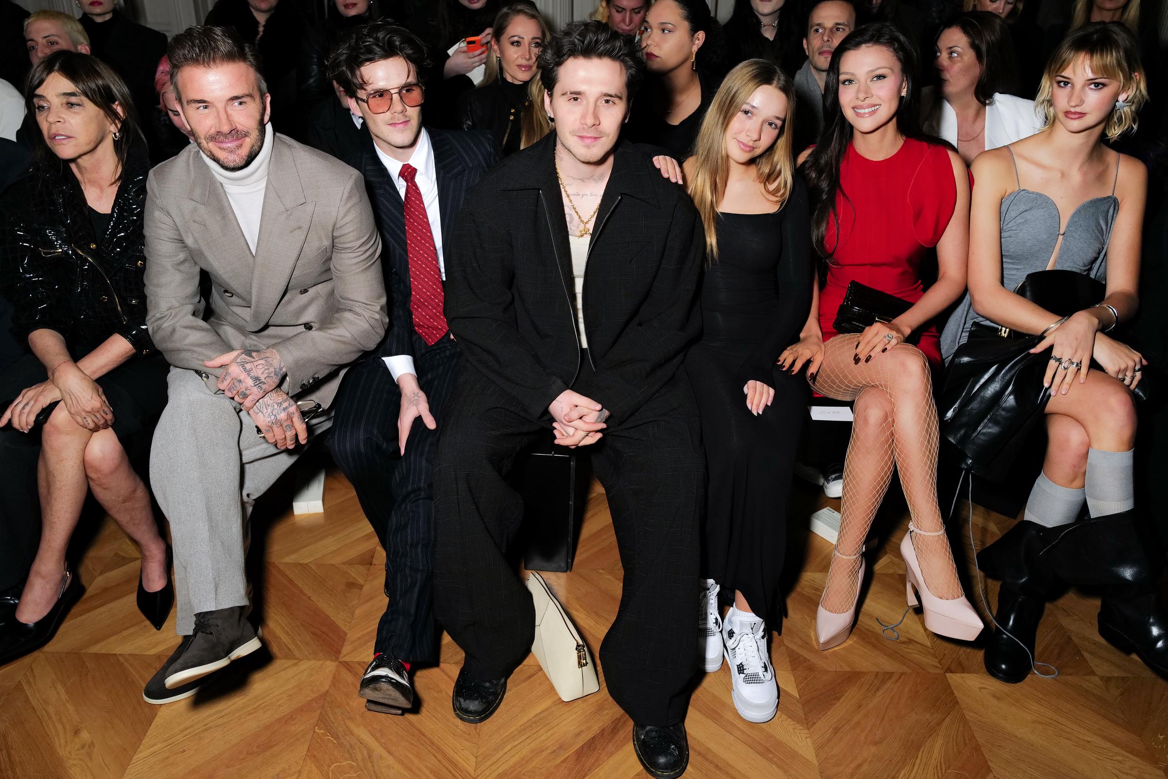 Carine Roitfeld, David Beckham, Cruz Beckham Brooklyn Peltz Beckham, Harper Beckham, Nicola Peltz Beckham and Mia Regan attend the Victoria Beckham AW24 show during Paris Fashion Week on March 01, 2024 in Paris, France. | Source: Getty Images