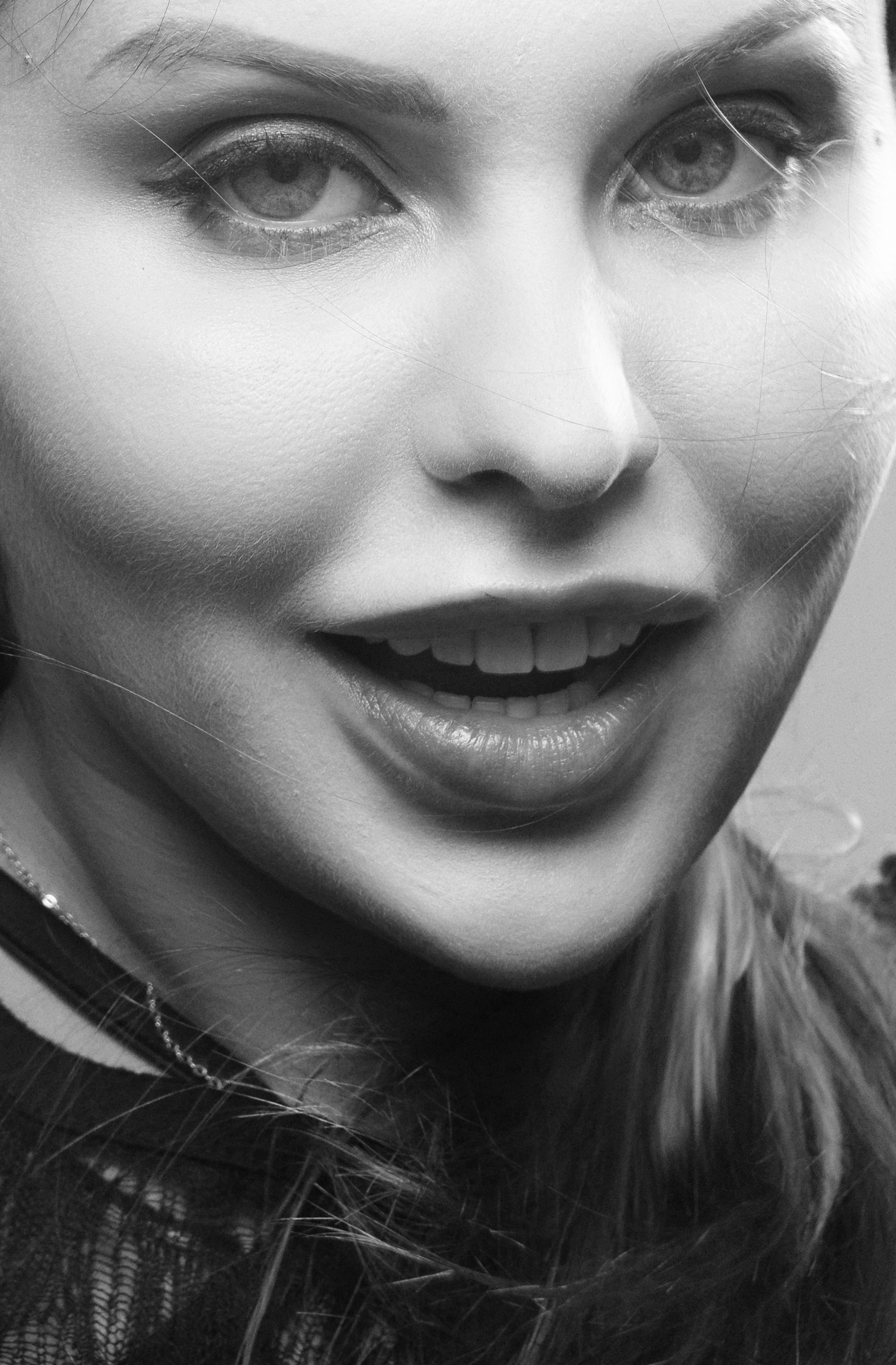 Grayscale portrait of a smiling woman | Source: Unsplash