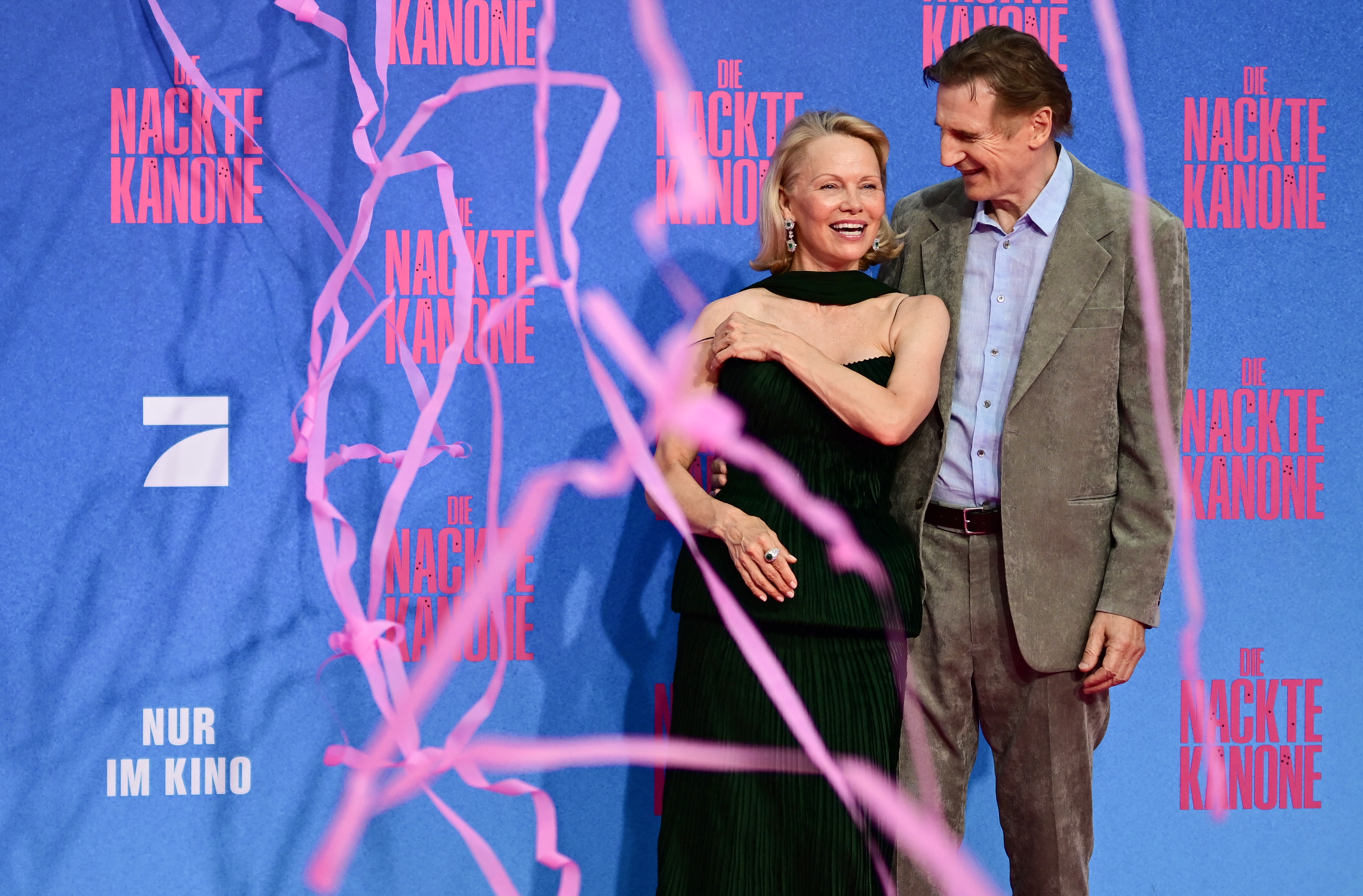 Pamela Anderson and Liam Neeson attend the Berlin premiere of the movie "The Naked Gun" (German Title: Die Nackte Kanone) at UCI Luxe East Side Gallery on July 24, 2025, in Berlin, Germany. | Source: Getty Images