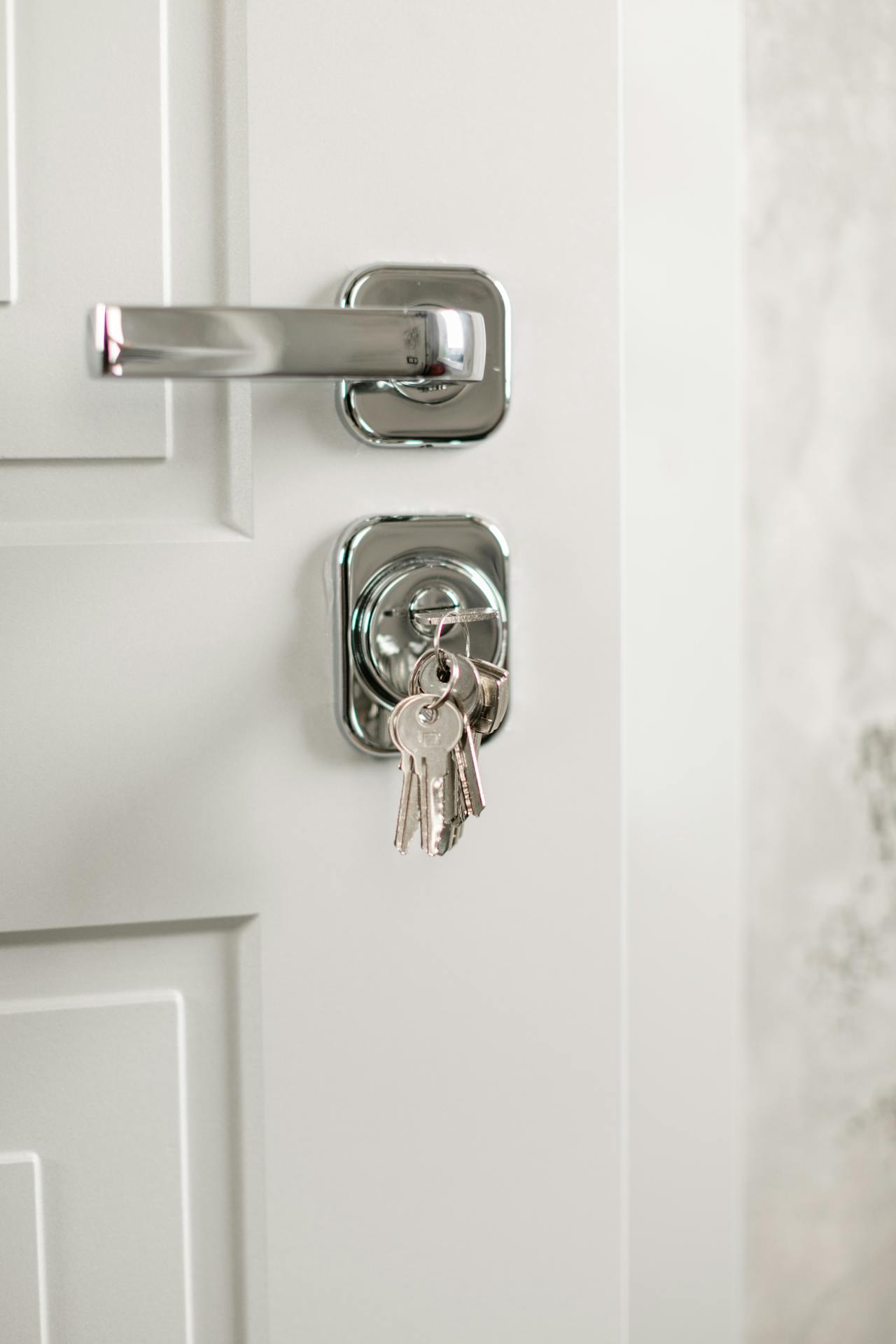 A key inserted in the lock of the front door | Source: Pexels