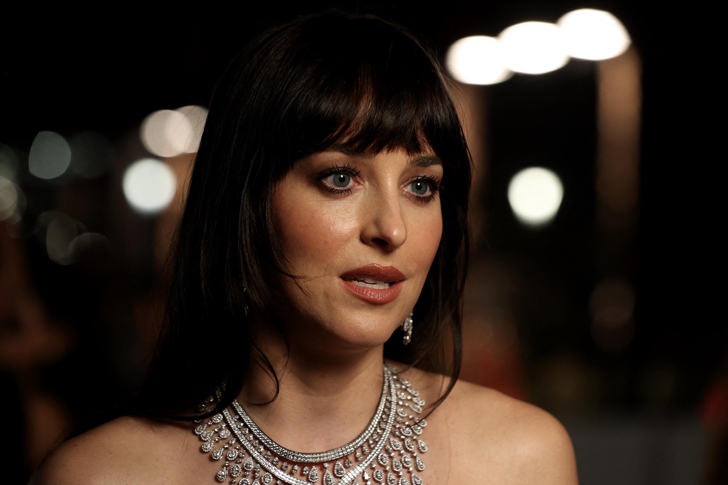 Dakota Johnson arrives for the opening ceremony of the 5th edition of the Red Sea Film Festival in Jeddah on December 4, 2025. | Source: Getty Images