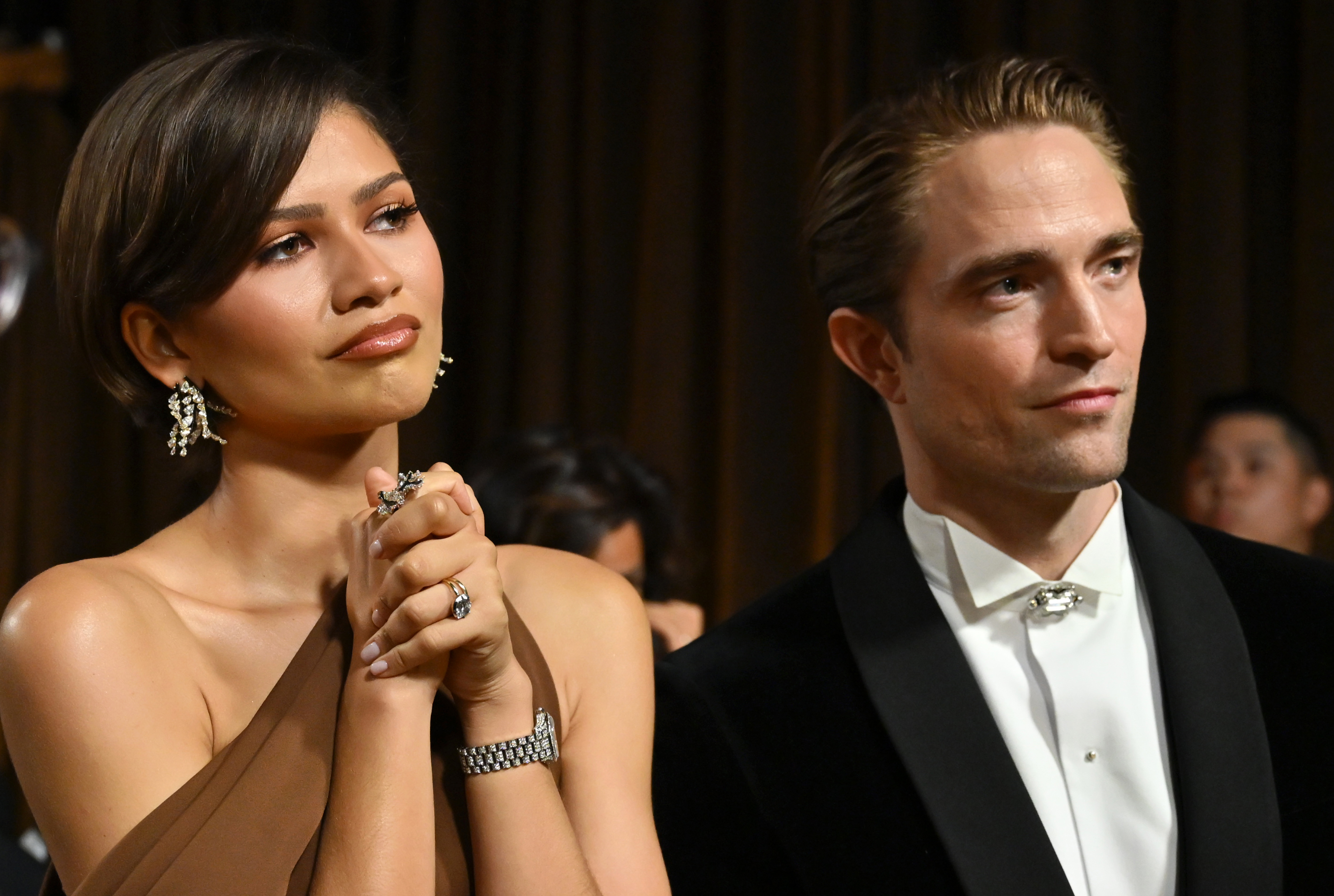 Zendaya and Robert Pattinson look on backstage during the 98th Oscars at Dolby Theatre on March 15, 2026 in Hollywood, California. | Source: Getty Images