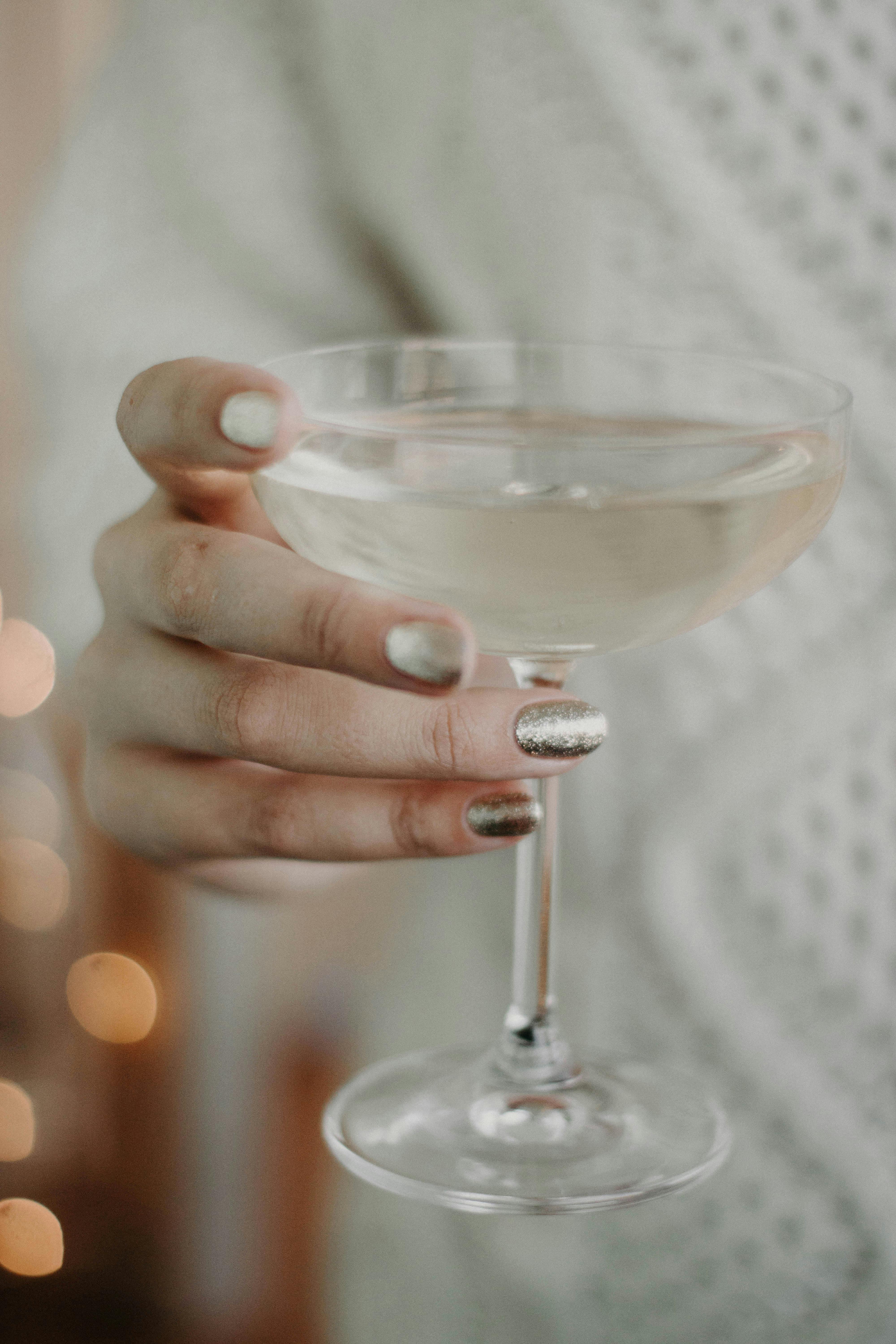 A woman holding a drink to make a toast | Source: Pexels