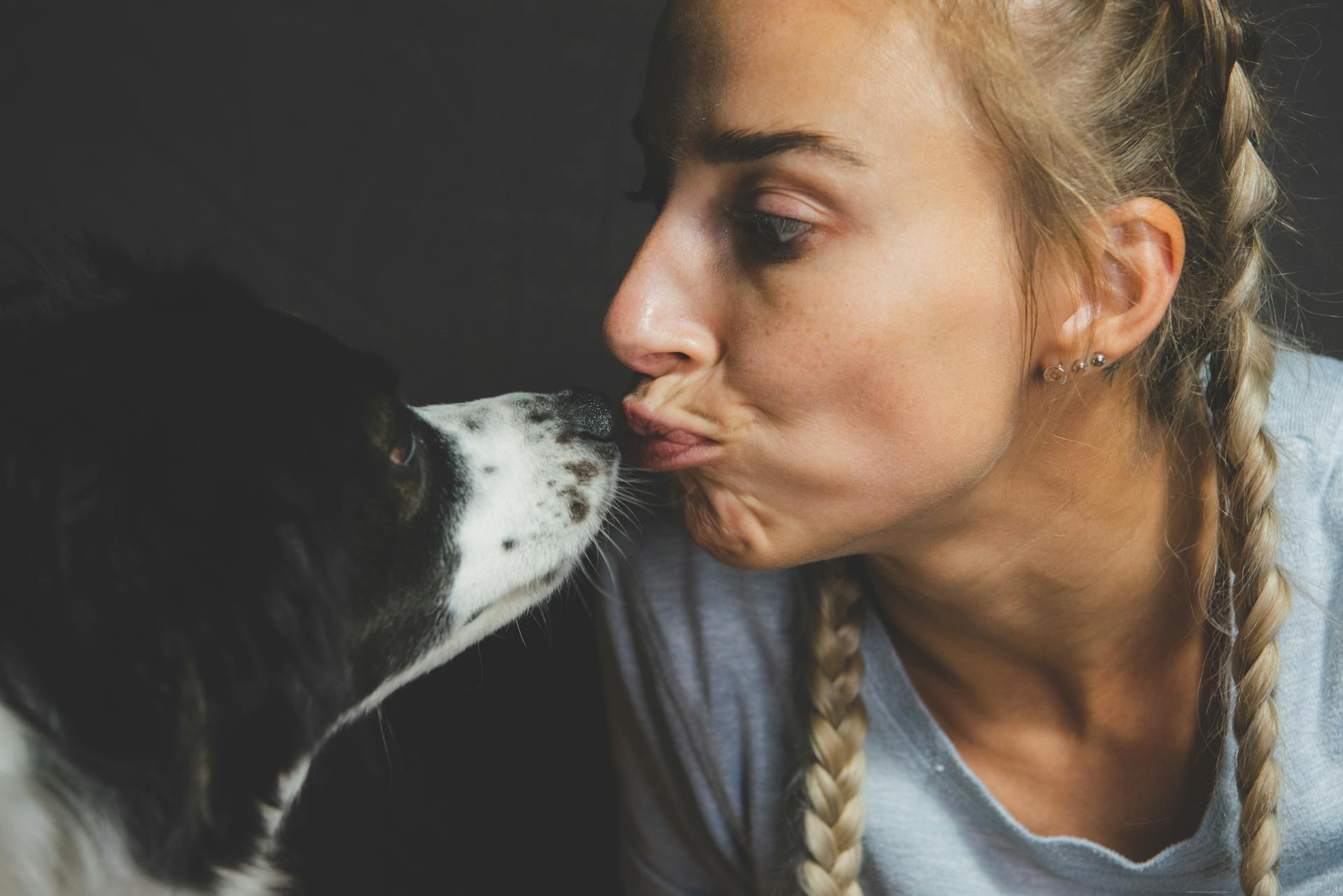 A woman and a dog sharing a tender moment | Source: Pexels