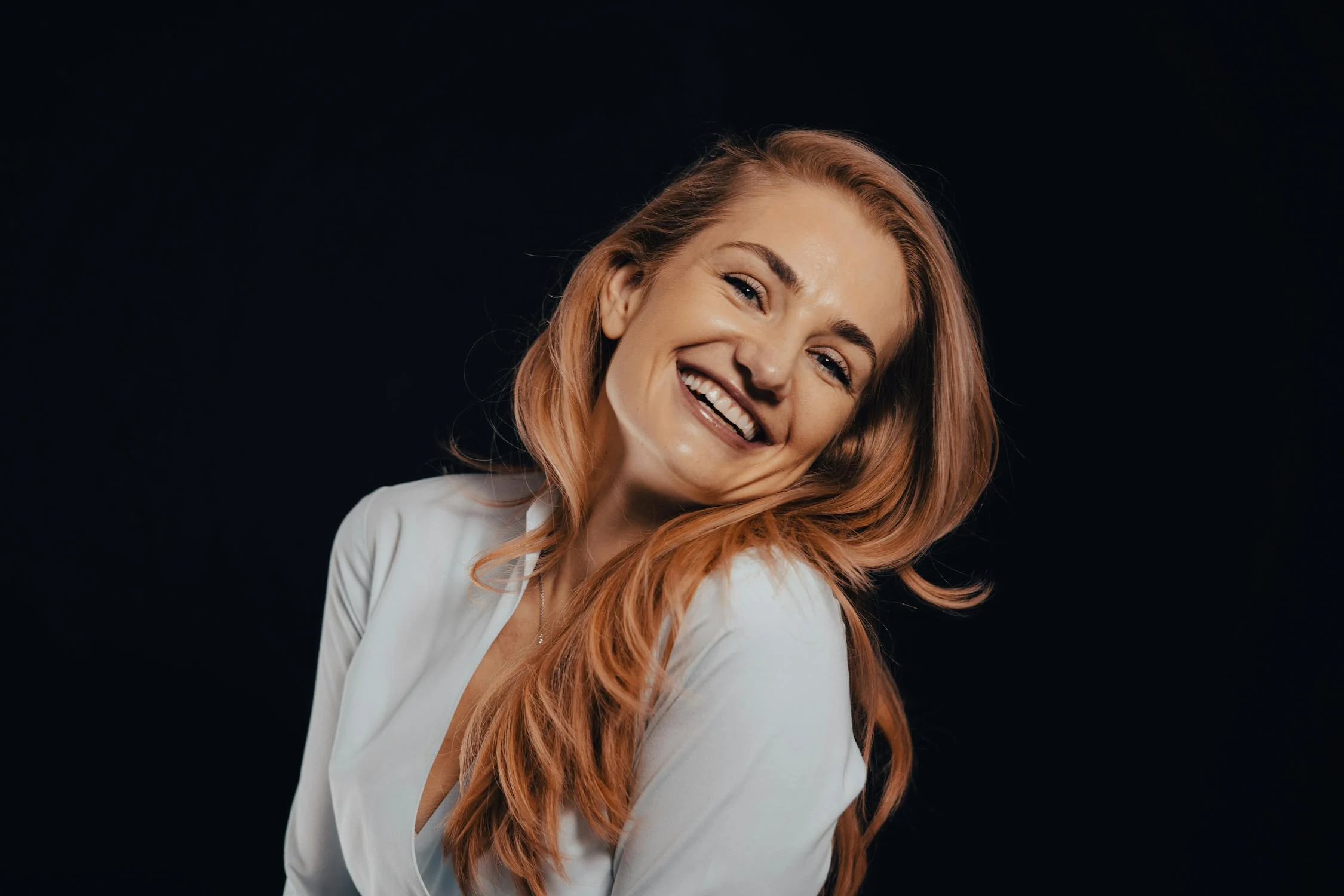 A happy woman in a white shirt | Source: Pexels