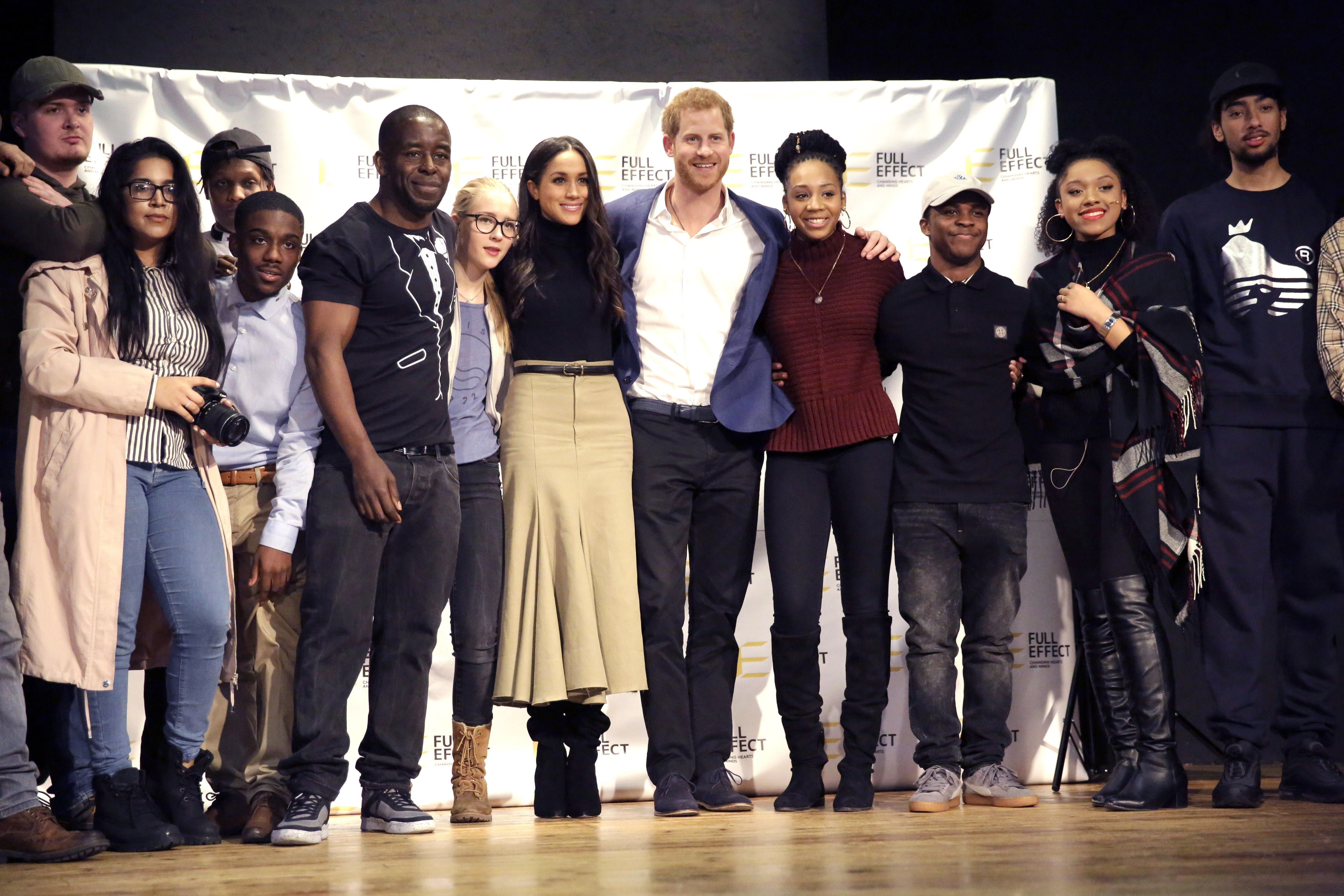 Prince Harry and Meghan Markle pose for a photograph with the cast and crew of a hip hop opera performed by young people involved in the Full Effect programme at the Nottingham Academy school on December 1, 2017, in Nottingham, England. | Source: Getty Images