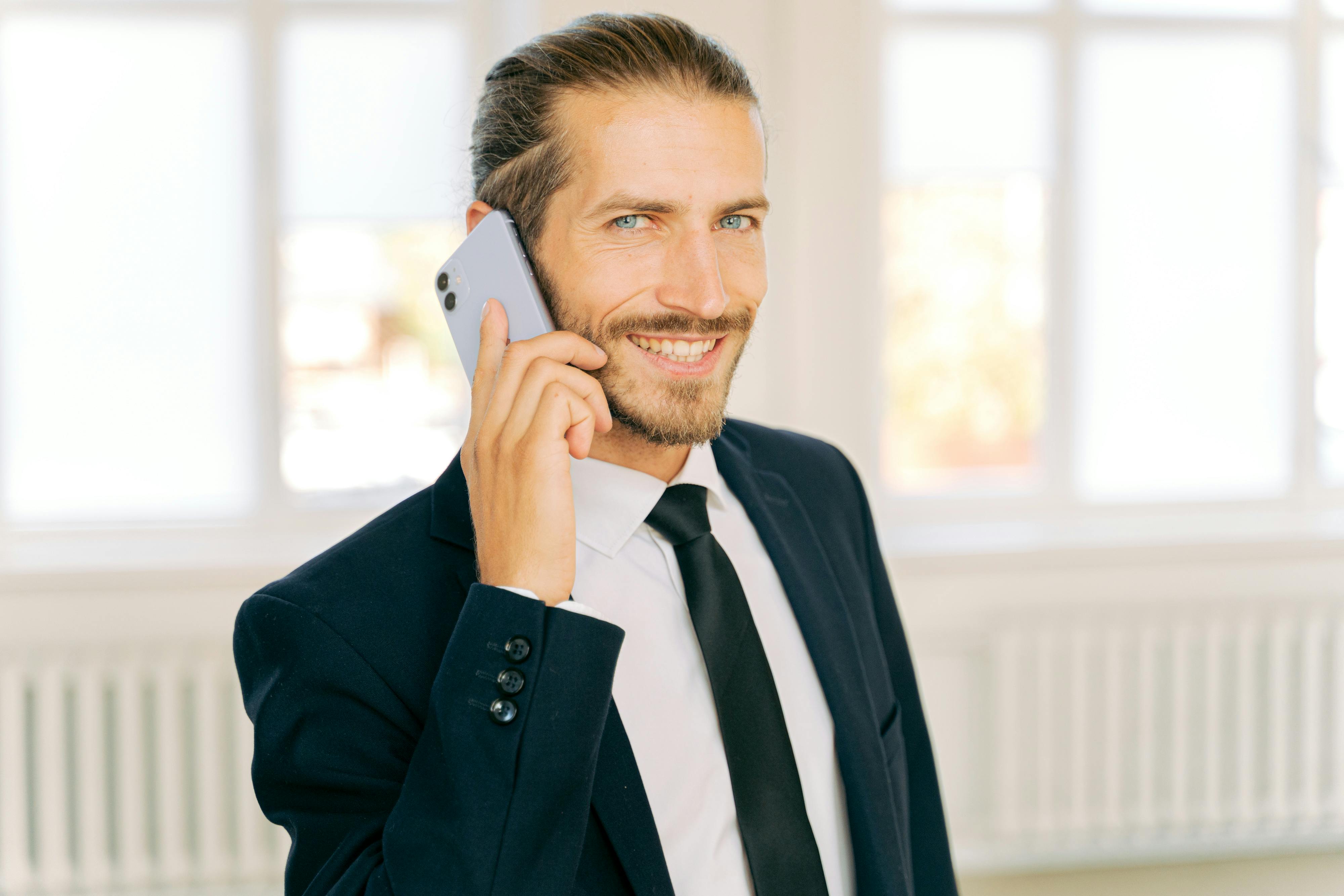 Man smiling while on phone | Source: Pexels