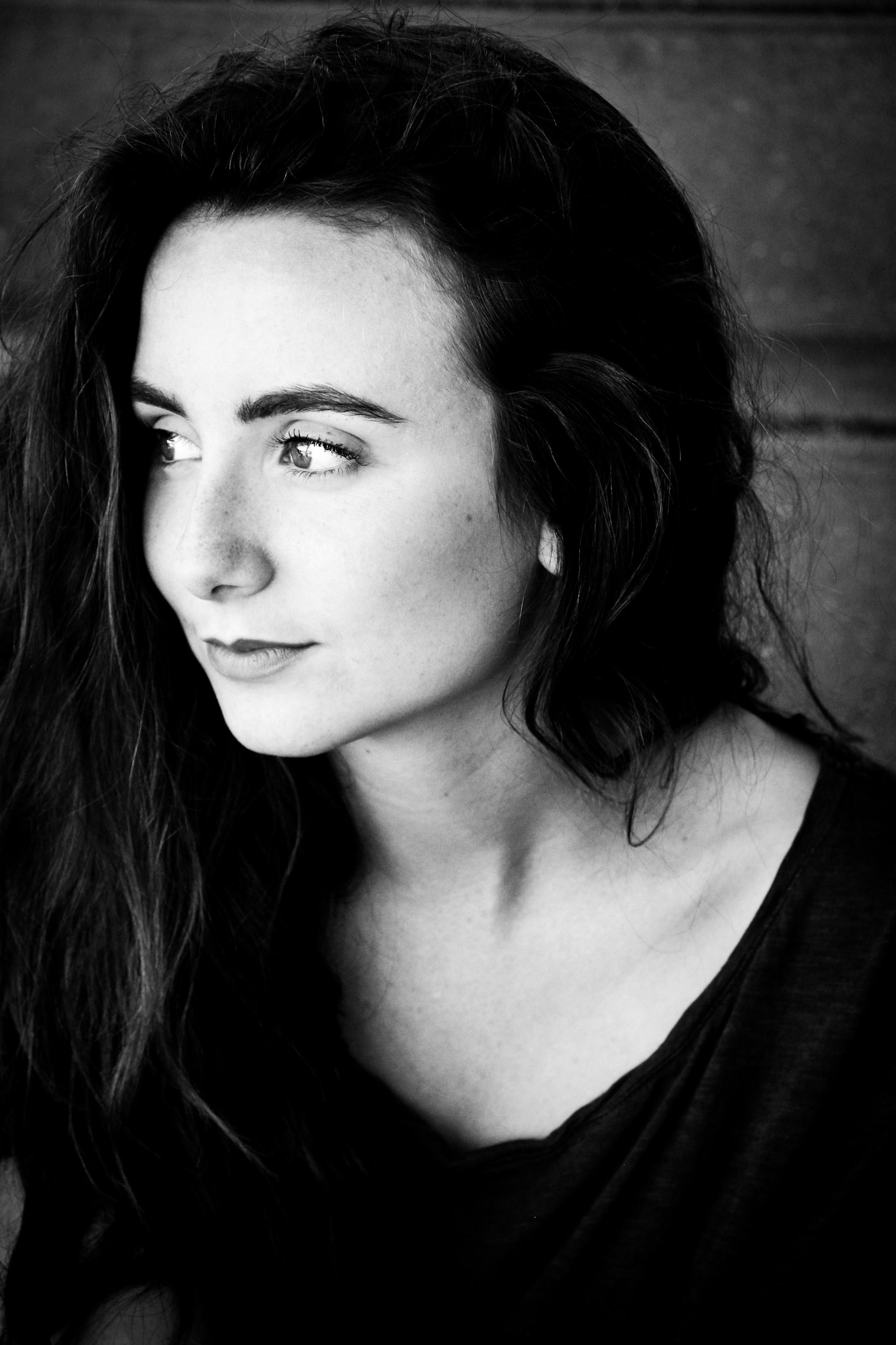 A thoughtful woman smirking | Source: Pexels