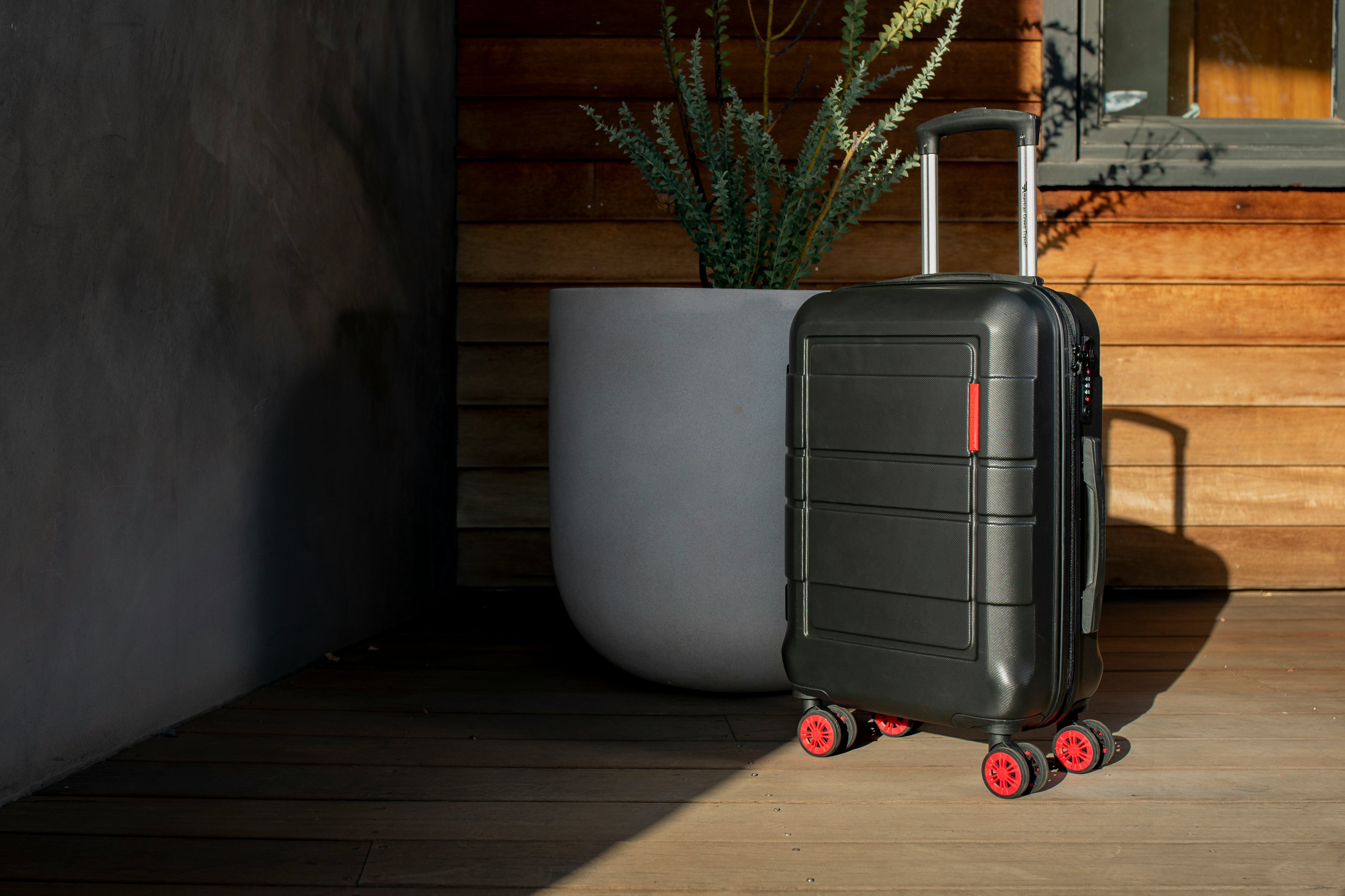 My MIL Demanded I Leave My Own Home During the Birthday Party I Organized for Her – She Didn't Know How Big a Mistake That Was 22 A suitcase next to a potted plot | Source: Unsplash