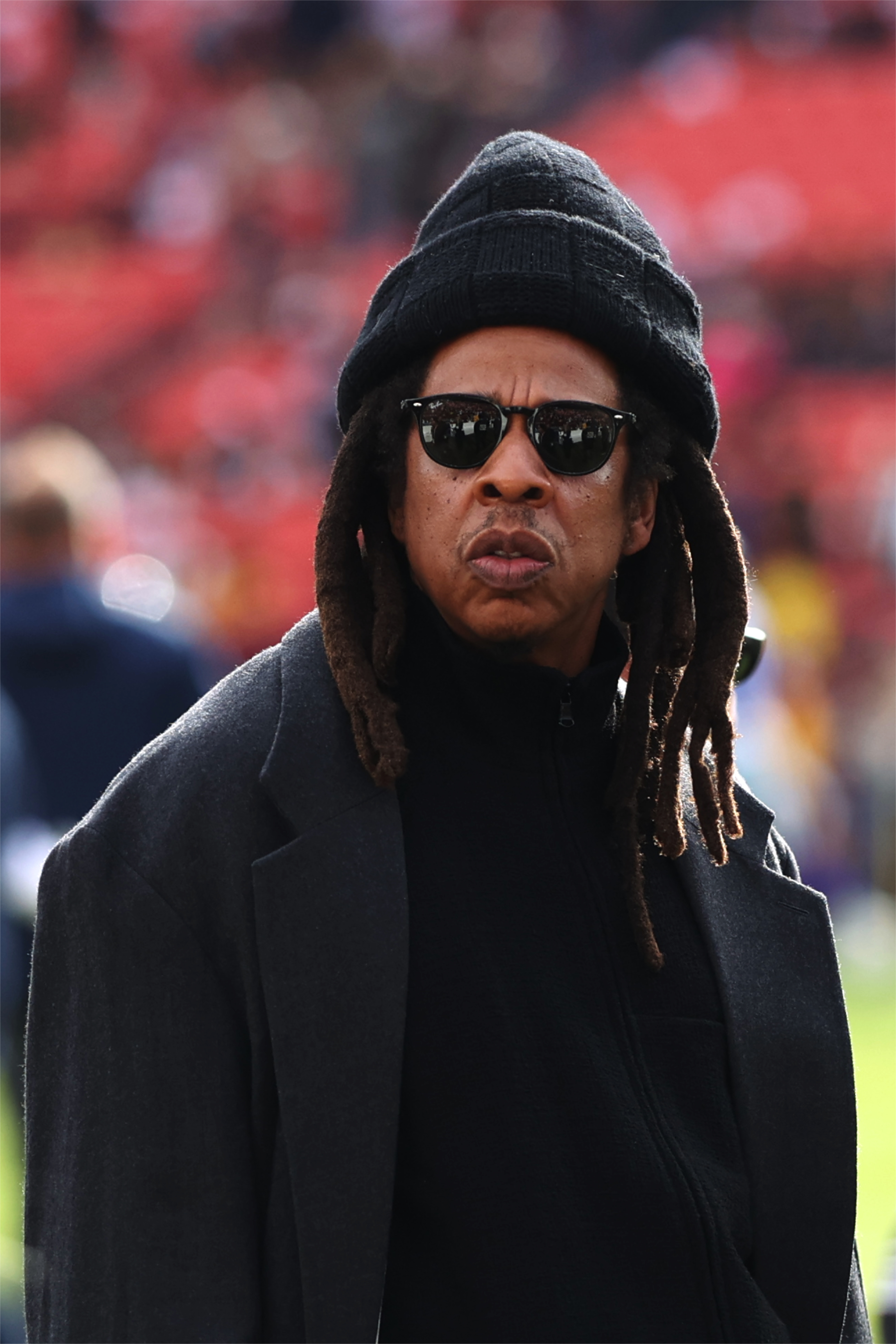 Rapper Jay-Z (C) looks on before a game between the Washington Commanders and the Dallas Cowboys at Northwest Stadium on November 24, 2024, in Landover, Maryland. | Source: Getty Images