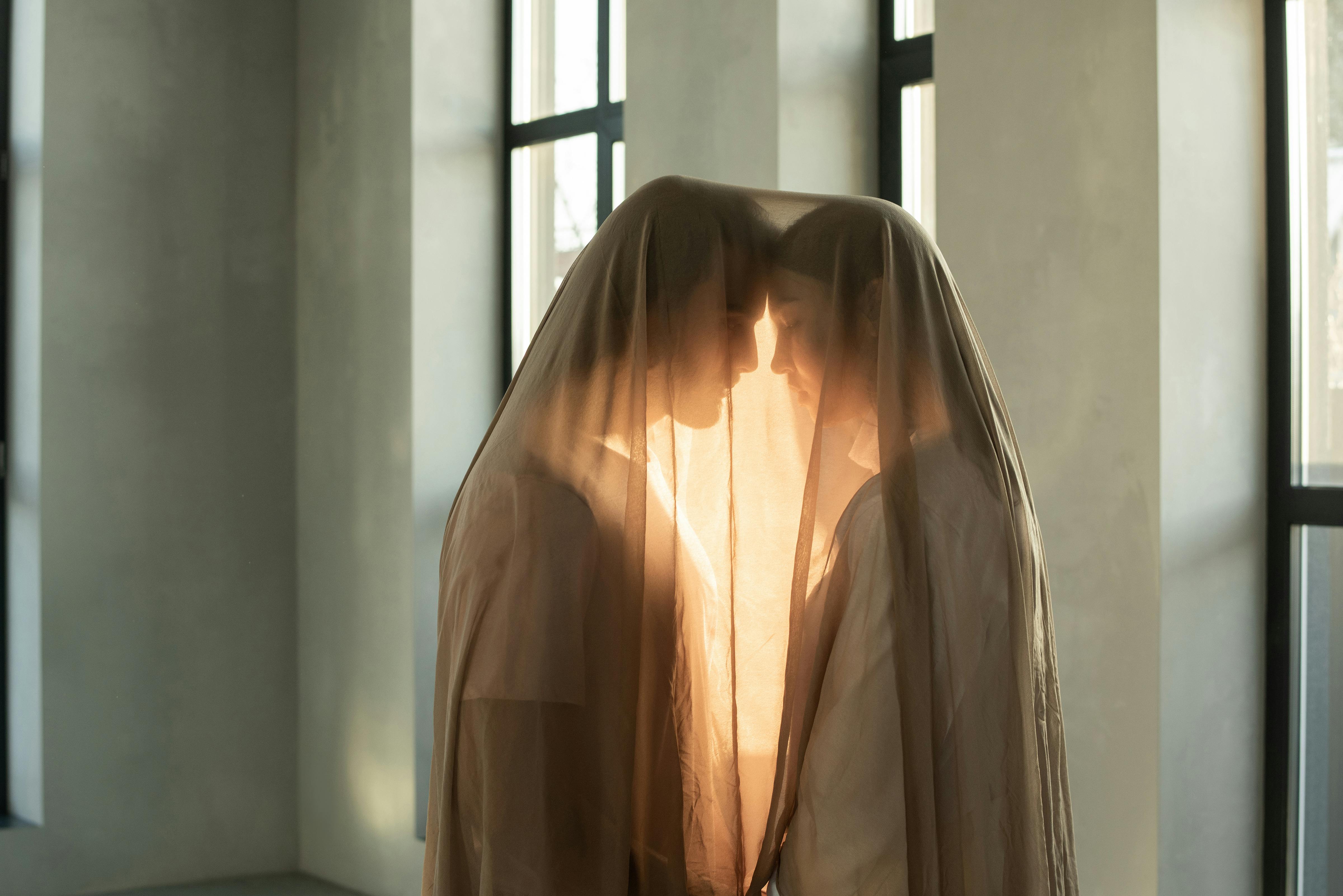 A couple under a sheet | Source: Pexels