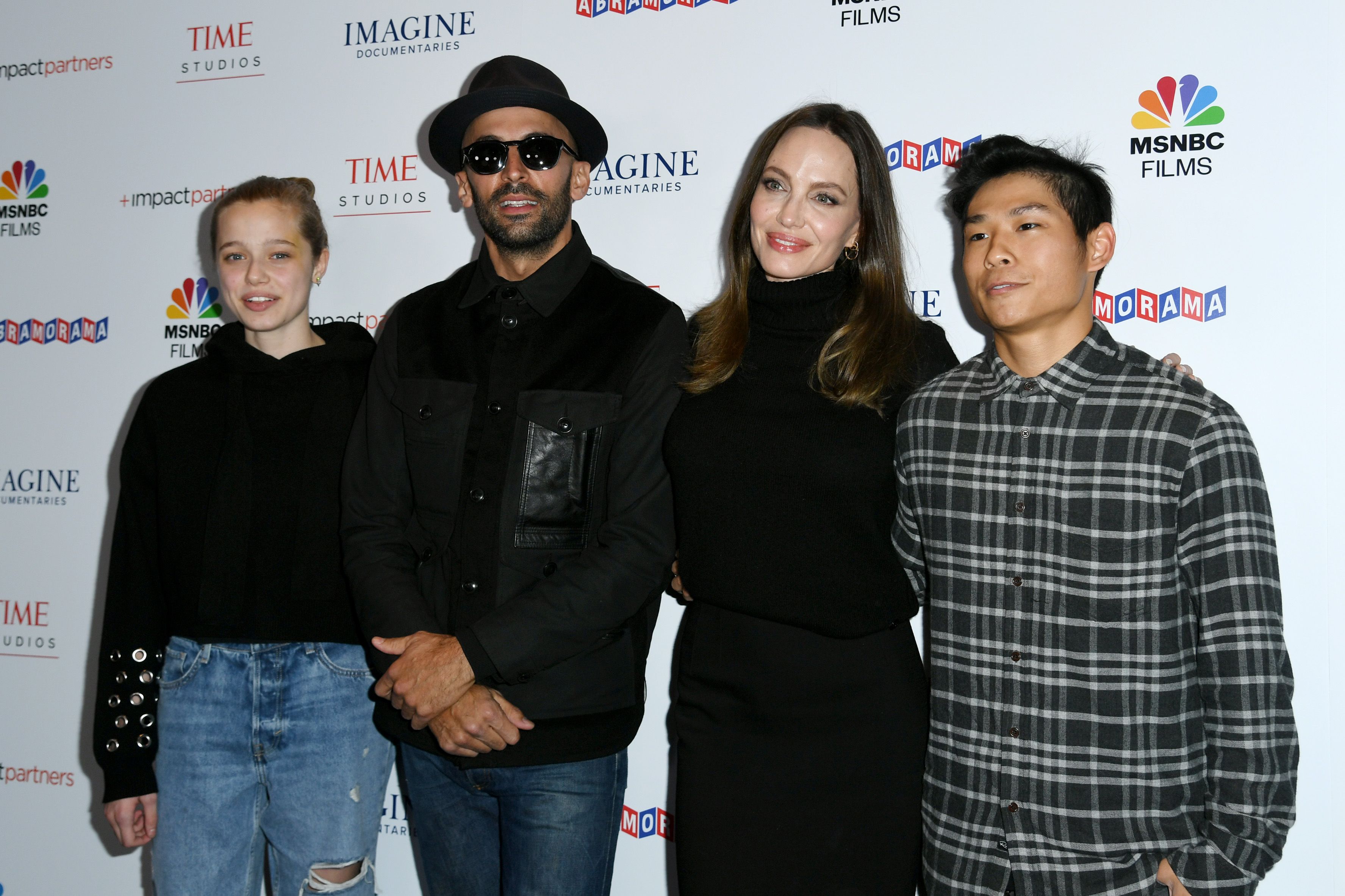 Shiloh Jolie Pitt, street artist JR, Angelina Jolie, and Pax Jolie-Pitt in Los Angeles on November 18, 2021 | Source: Getty Images