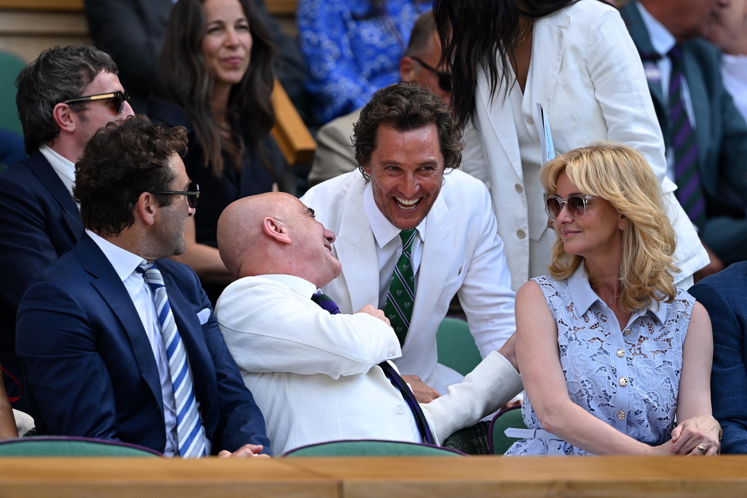 Matthew McConaughey shares a joke with former tennis player Andre Agassi in the royal box ahead of the Gentlemen's Singles final match between Jannik Sinner of Italy and Carlos Alcaraz of Spain on day fourteen of The Championships Wimbledon 2025 at All England Lawn Tennis and Croquet Club on July 13, 2025 in London, England | Source: Getty Images