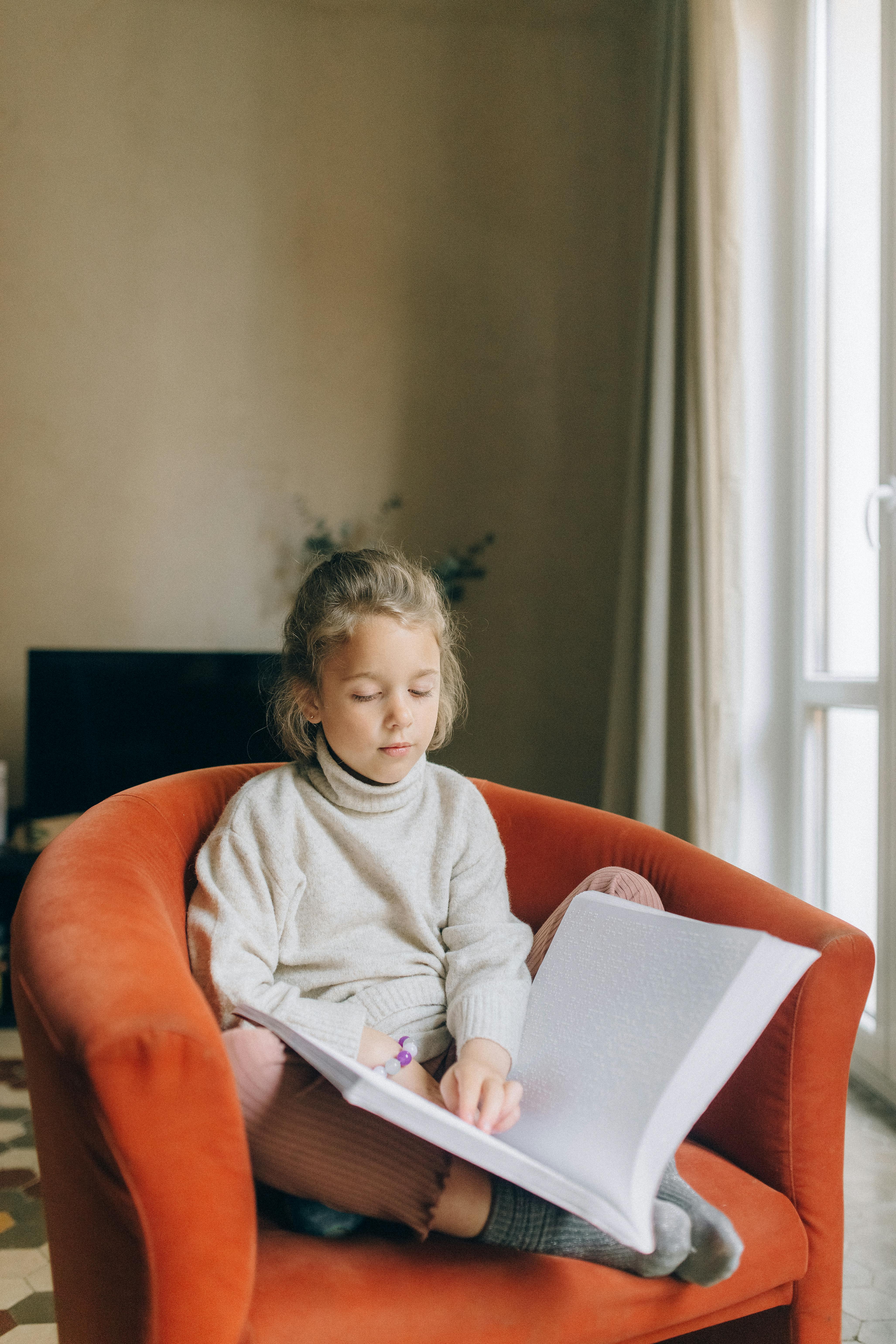 A girl reading Braille | Source: Pexels