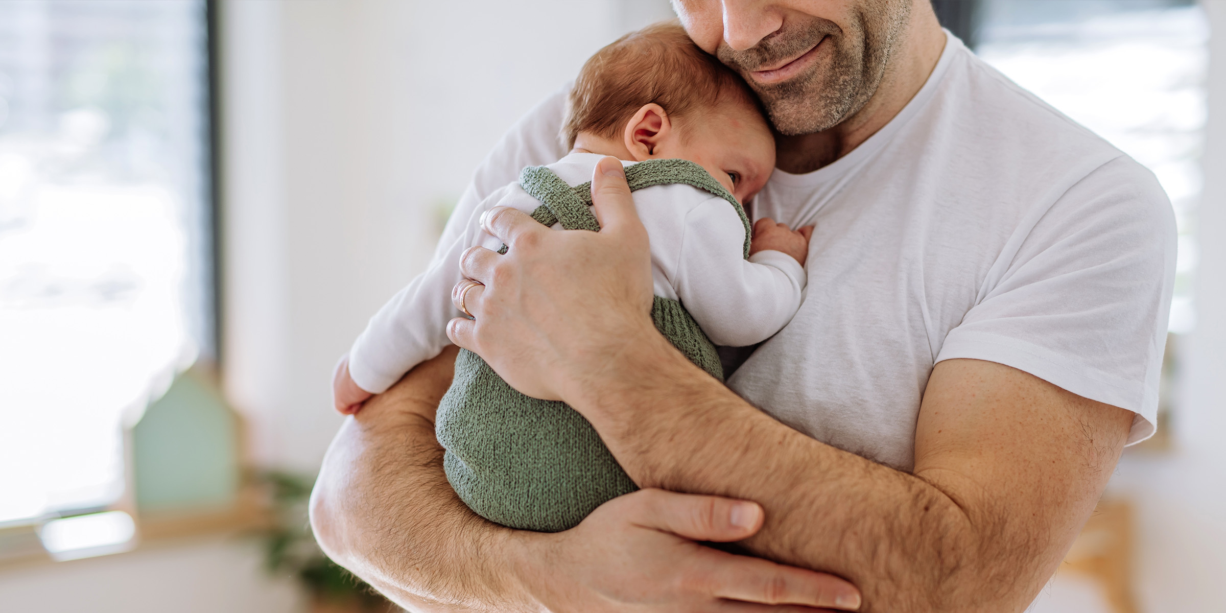 A man holding a baby | Source: Shutterstock