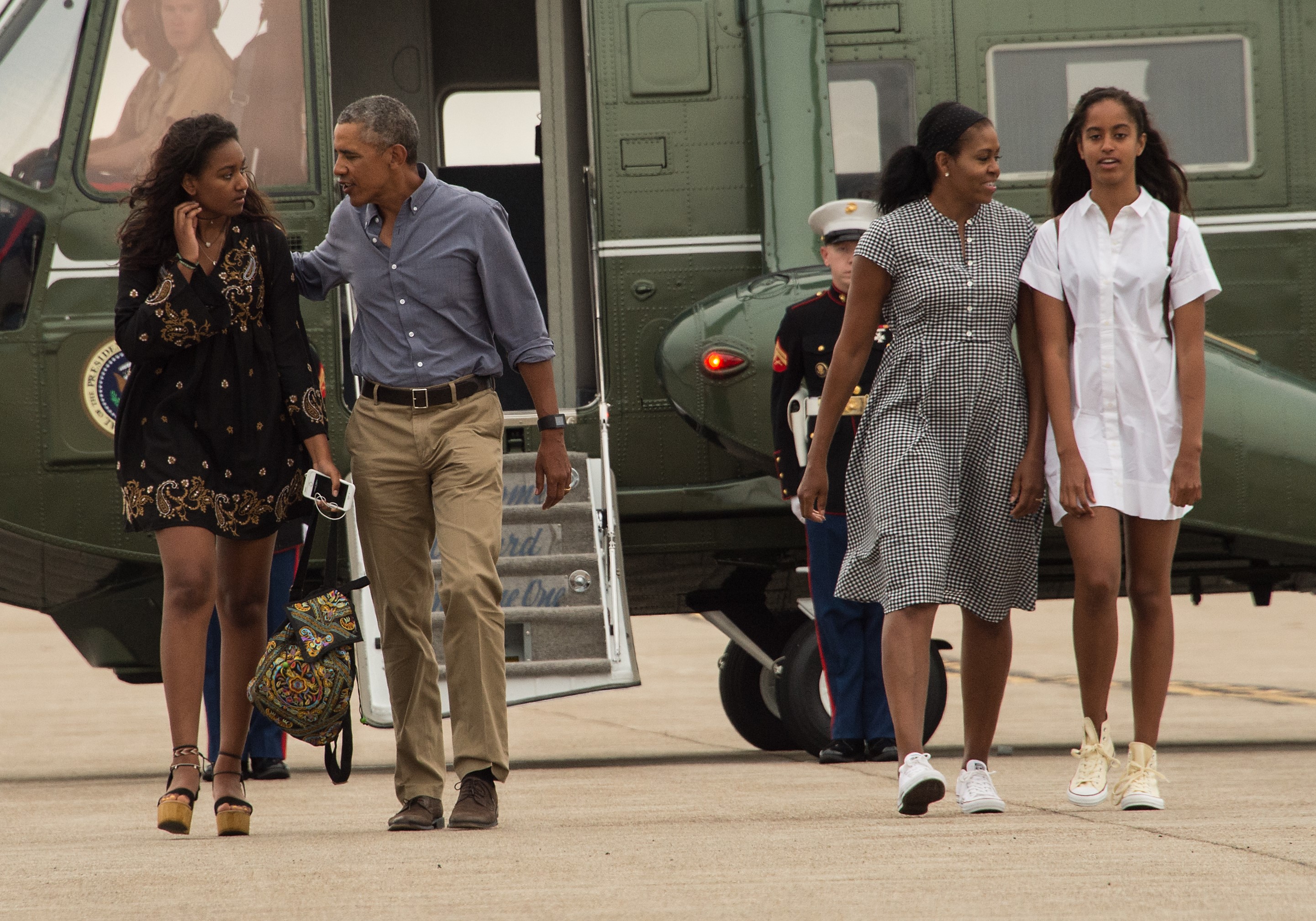 President Barack Obama, First Lady Michelle Obama and daughters Malia and Sasha walk to board Air Force One at Cape Cod Air Force Station in Massachusetts on August 21, 2016 as they depart for Washington after a two-week holiday at nearby Martha's Vineyard. | Source: Getty Images