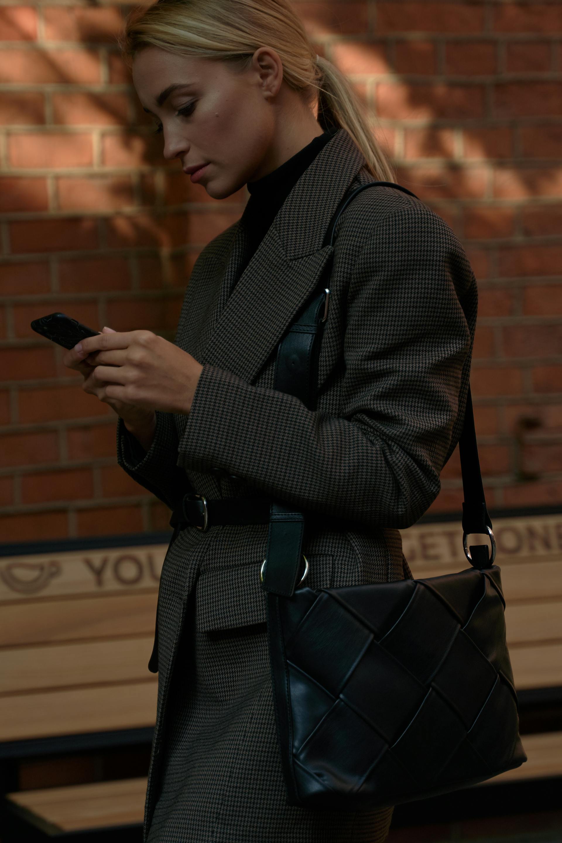 A serious woman looking at her phone | Source: Pexels