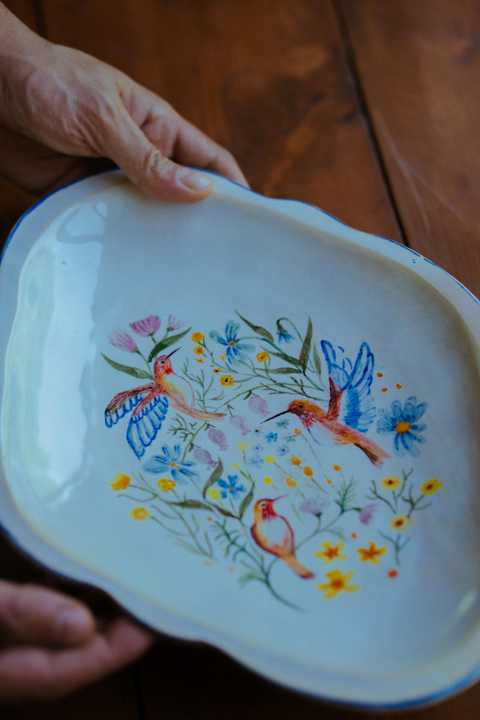 A woman holding a hand-painted ceramic dish | Source: Pexels