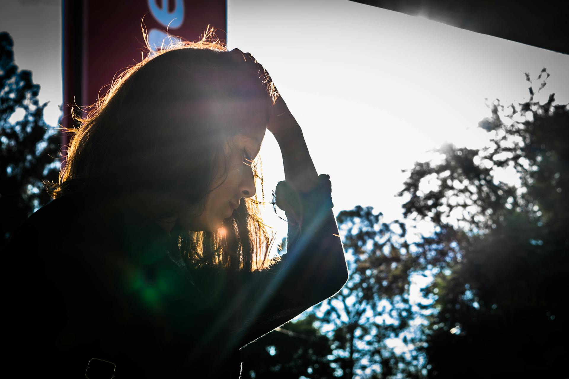 A woman standing near a window | Source: Pexels