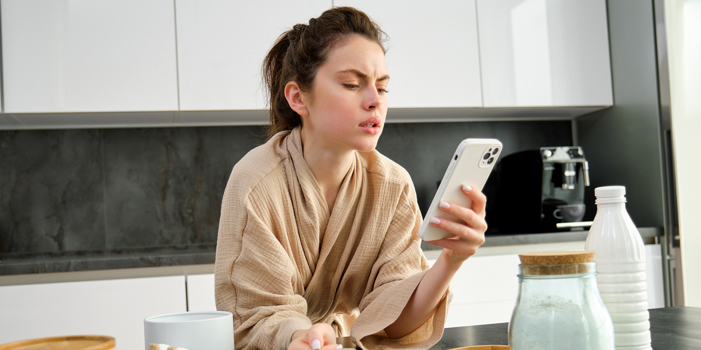 A young woman using her phone | Source: Shutterstock