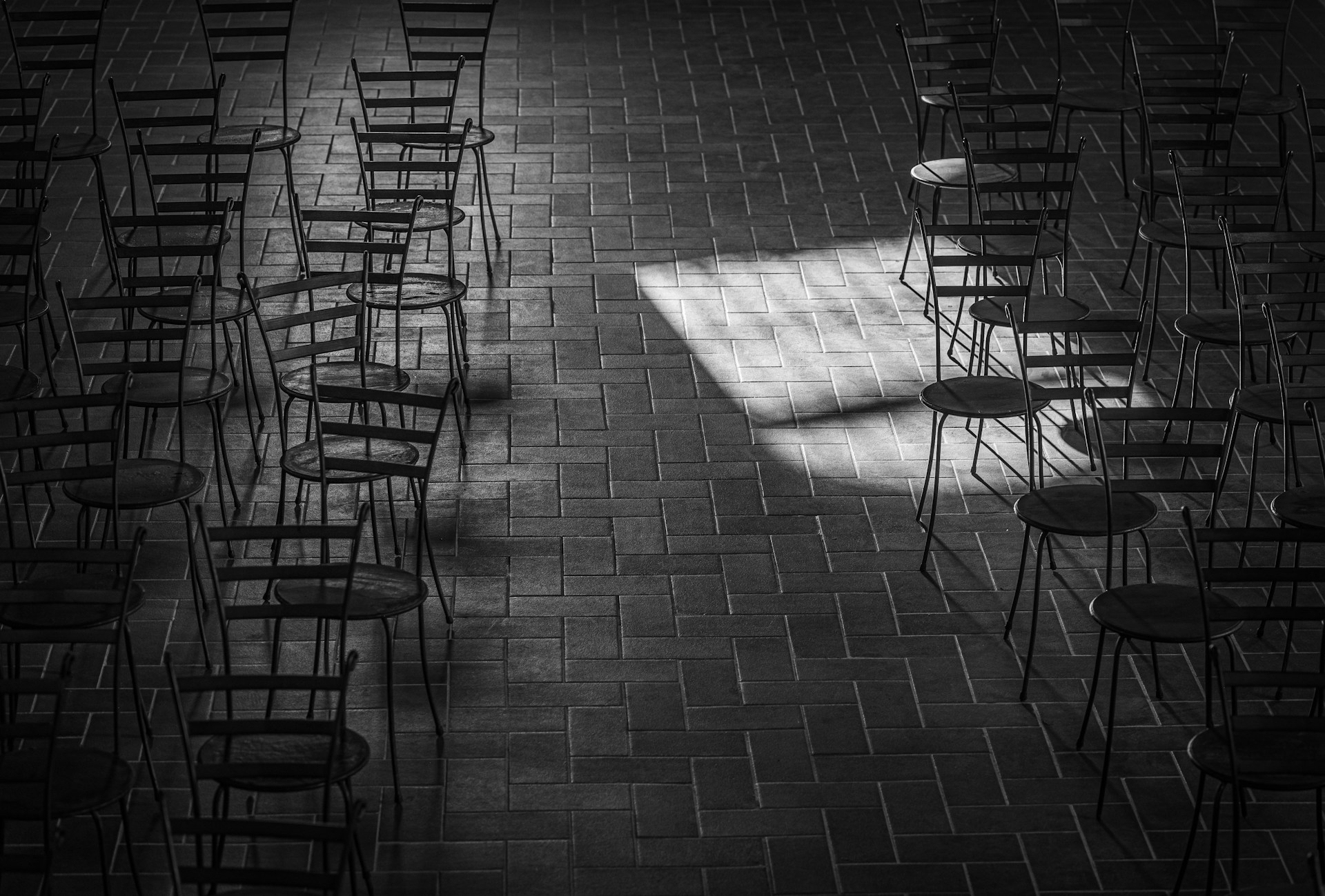 My Sister Made Me Eat in the Garage at Her Wedding Because 'There Wasn't Enough Space for Everyone Inside' 10 Grayscale shot of chairs in an empty room | Source: Unsplash