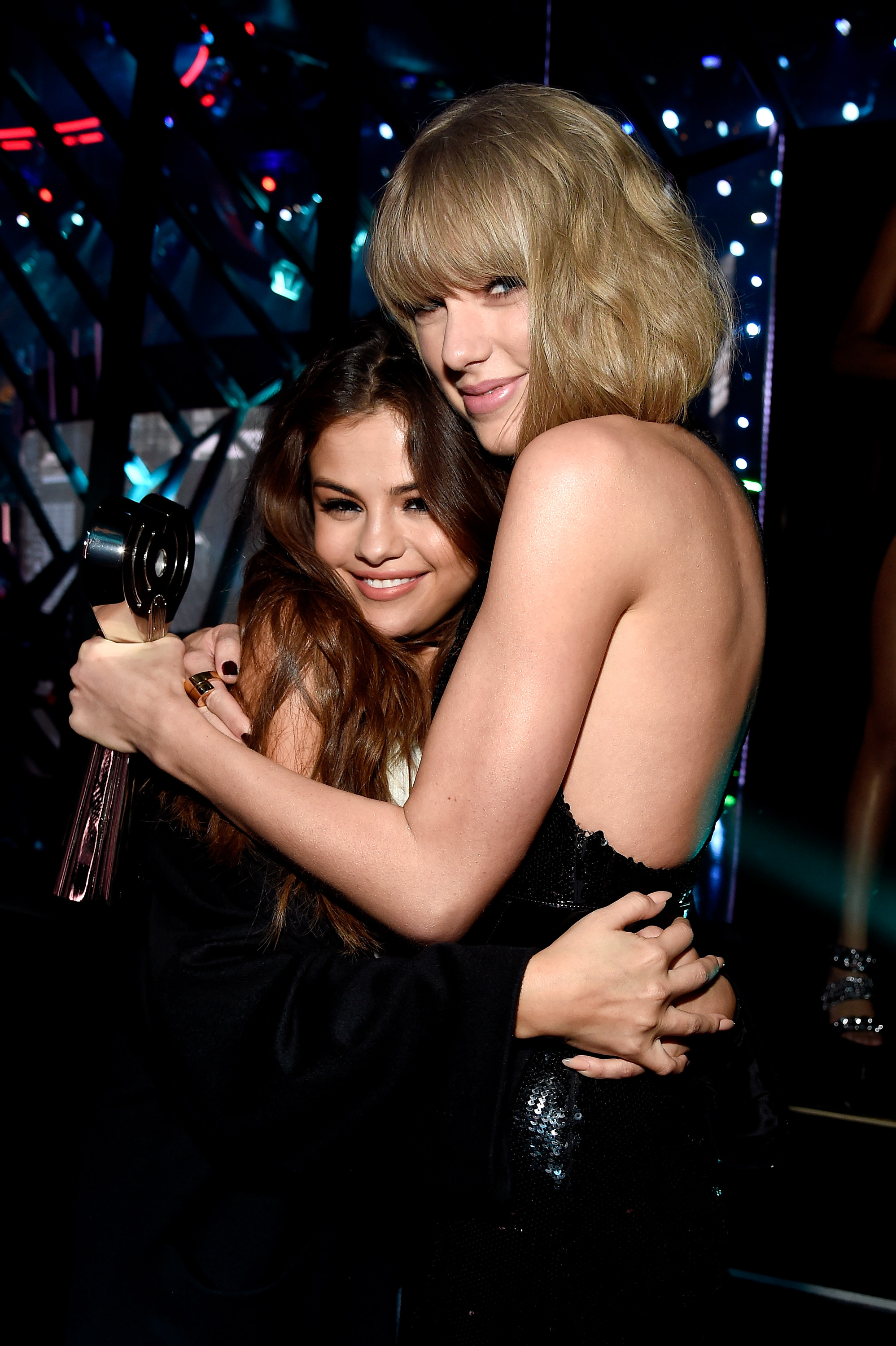 Taylor Swift embraces Selena Gomez backstage at the iHeartRadio Music Awards at The Forum on April 3, 2016, in Inglewood, California. | Source: Getty Images