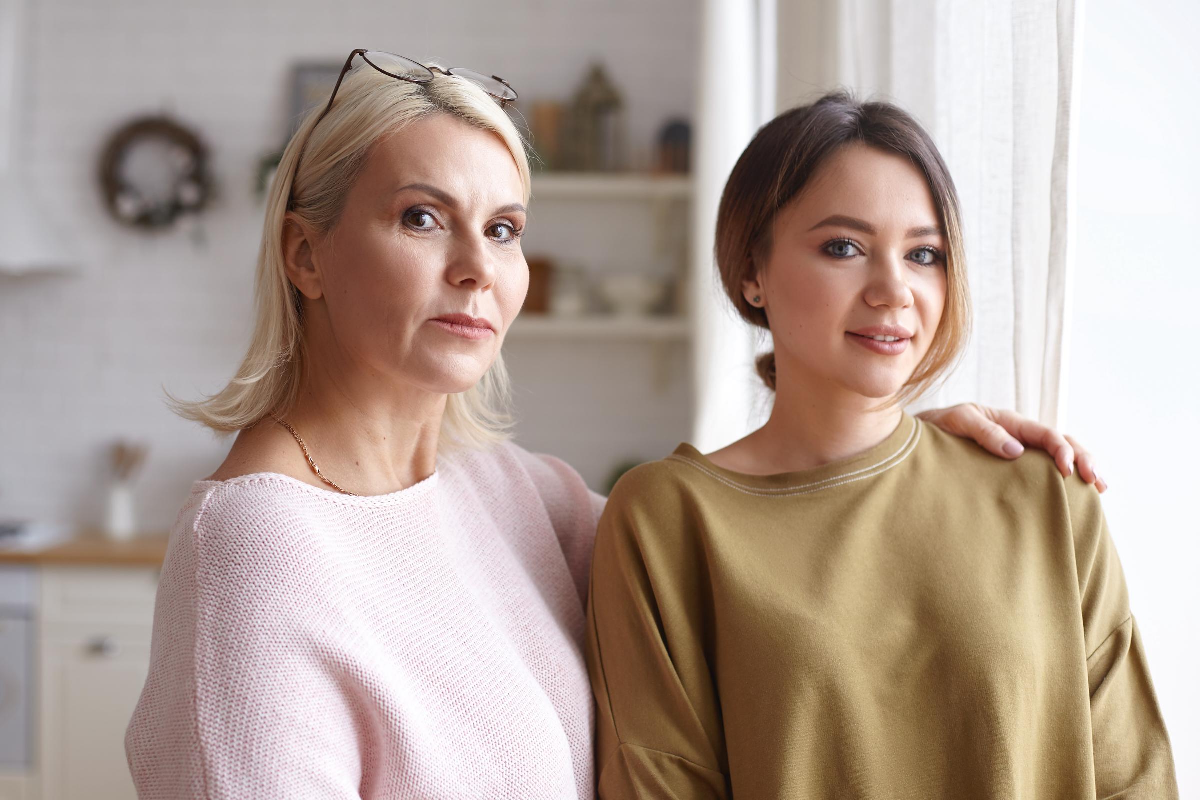 A younger woman with an overbearing older one | Source: Freepik