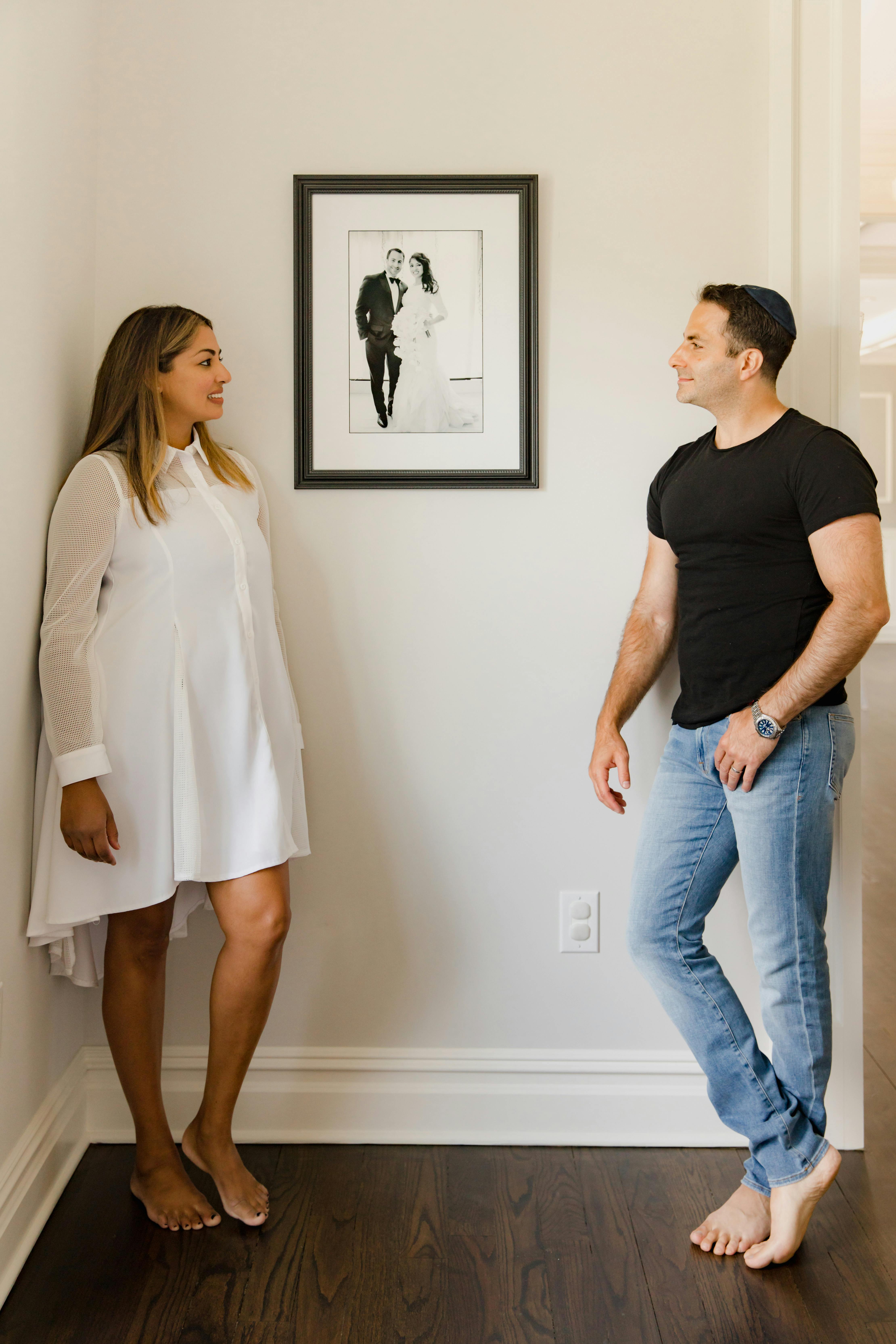 A couple standing between a picture frame | Source: Pexels