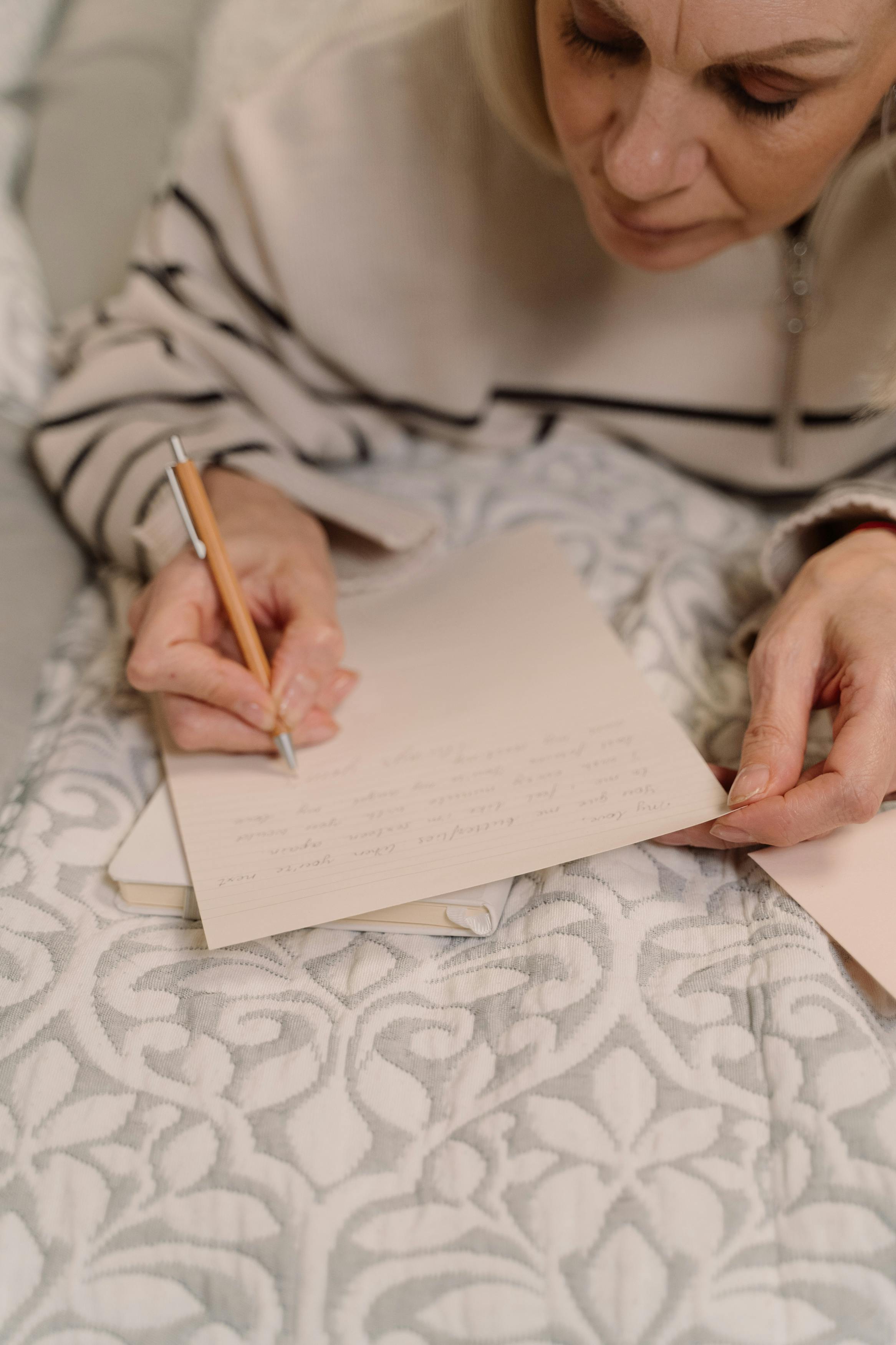 An older woman writing a letter | Source: Pexels