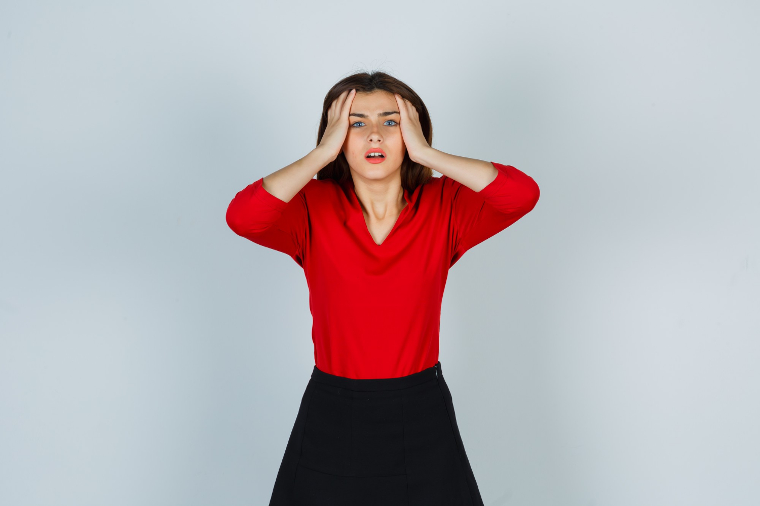A frustrated woman holding her head | Source: Freepik