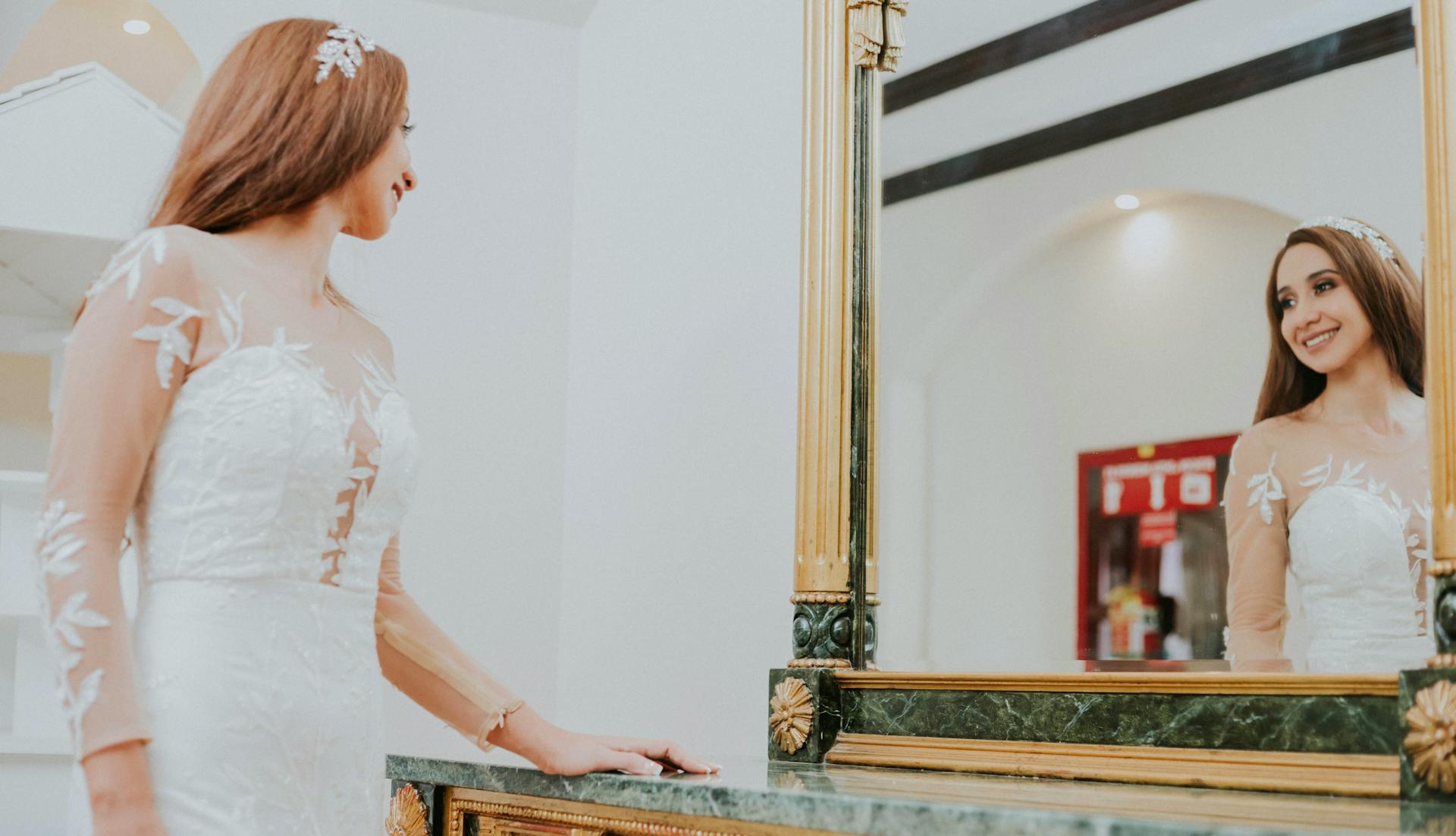 A thrilled bride admiring herself in the mirror | Source: Pexels