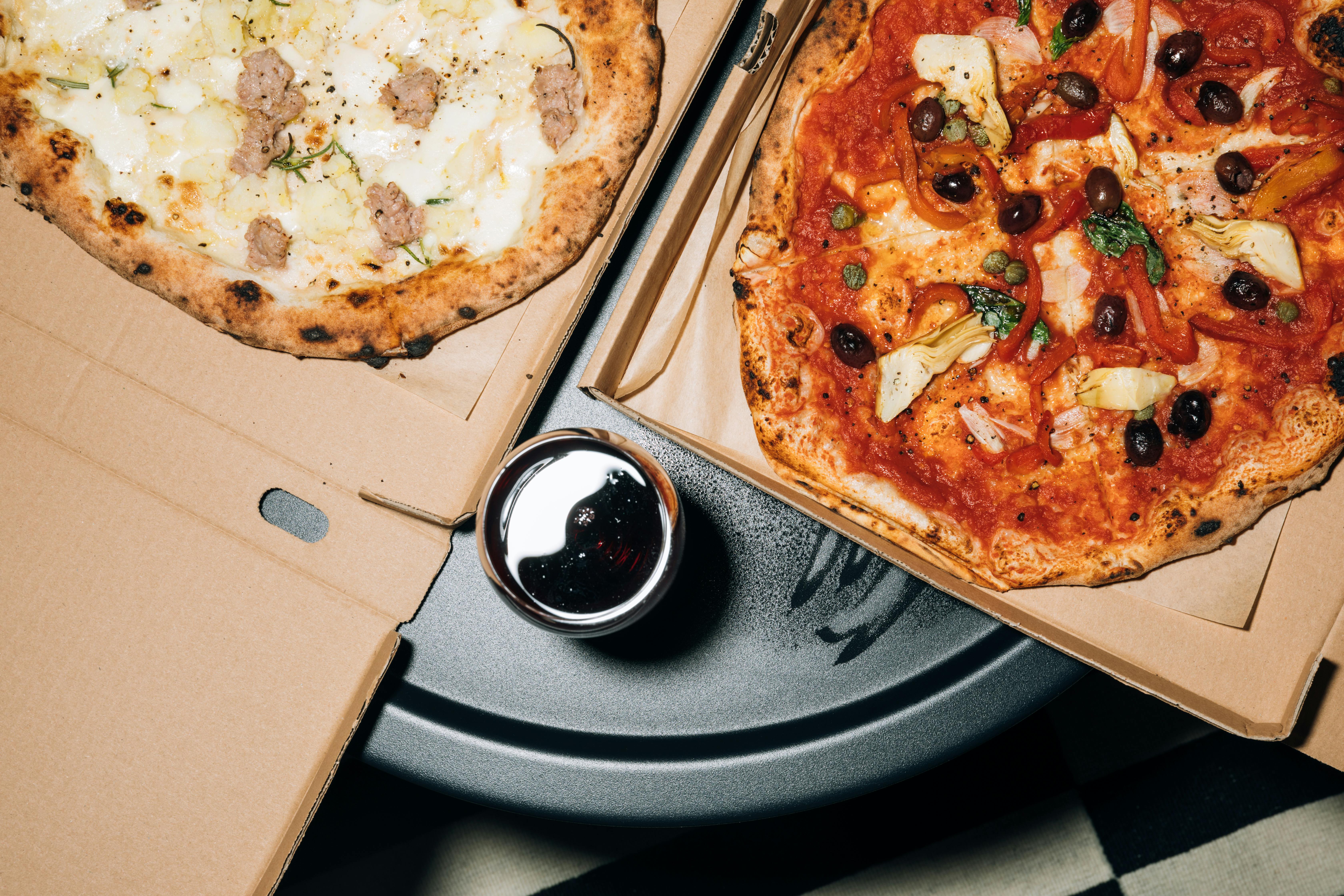 Boxes of pizza on a table | Source: Midjourney
