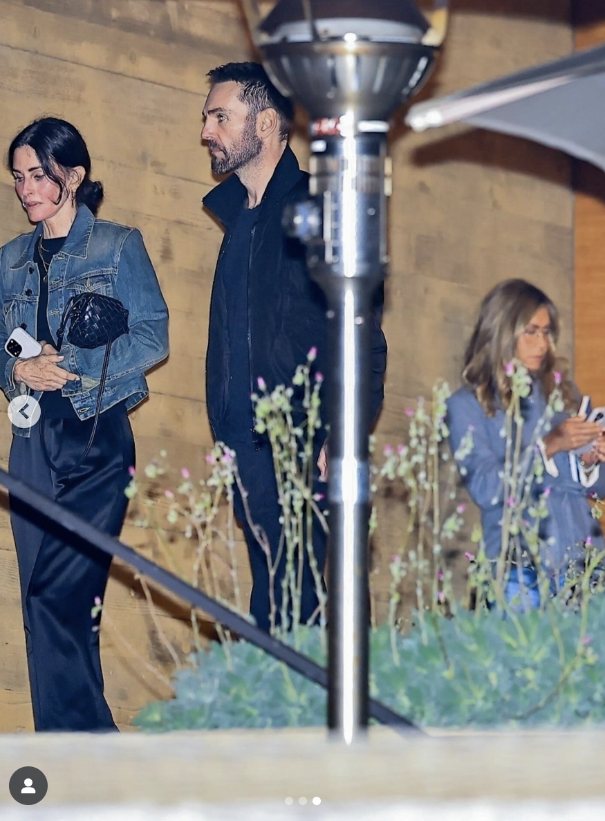 Jennifer Aniston trailing behind Courteney Cox and Johnny McDaid in Nobu, Malibu, on August 18, 2025. | Source: Instagram/justjared
