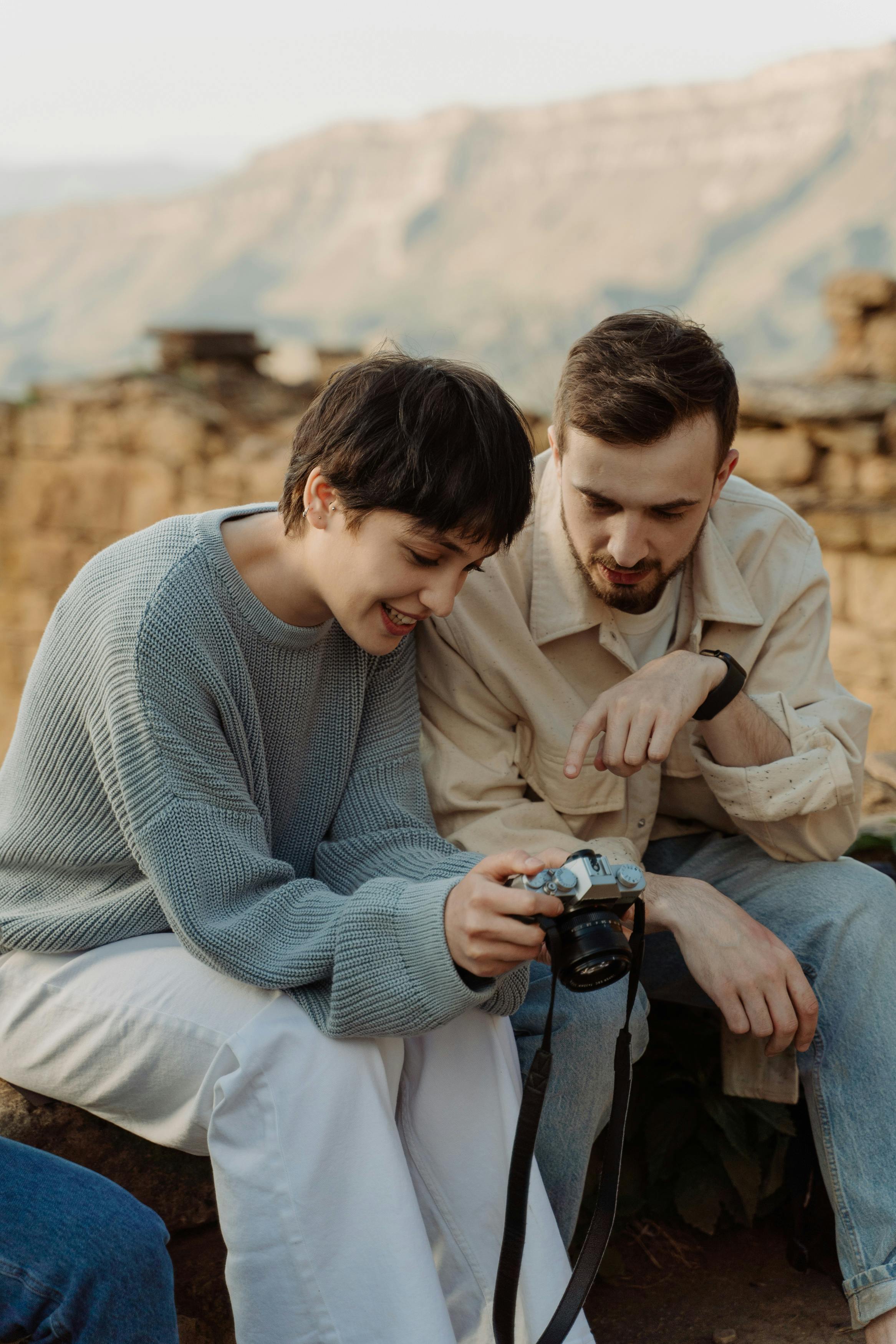 A man and a woman checking photos in the camera | Source: Pexels