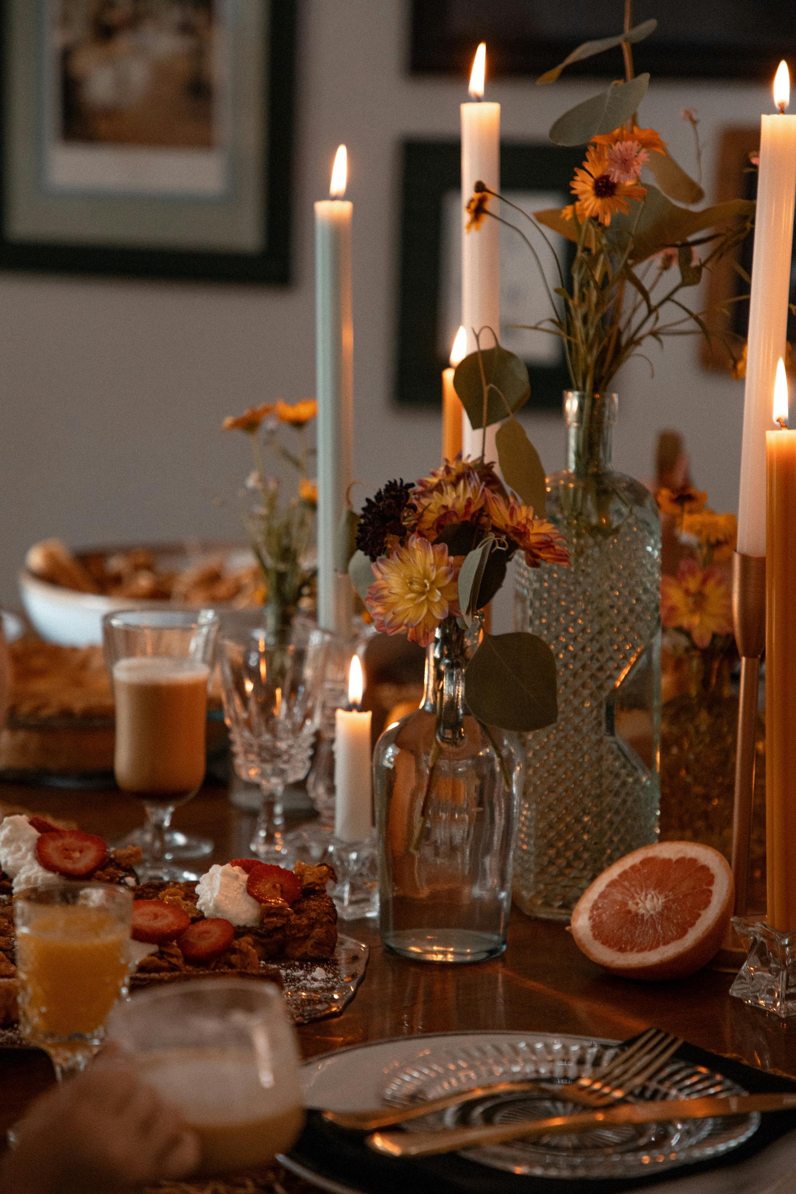 A dinner table set with candles and food | Source: Unsplash