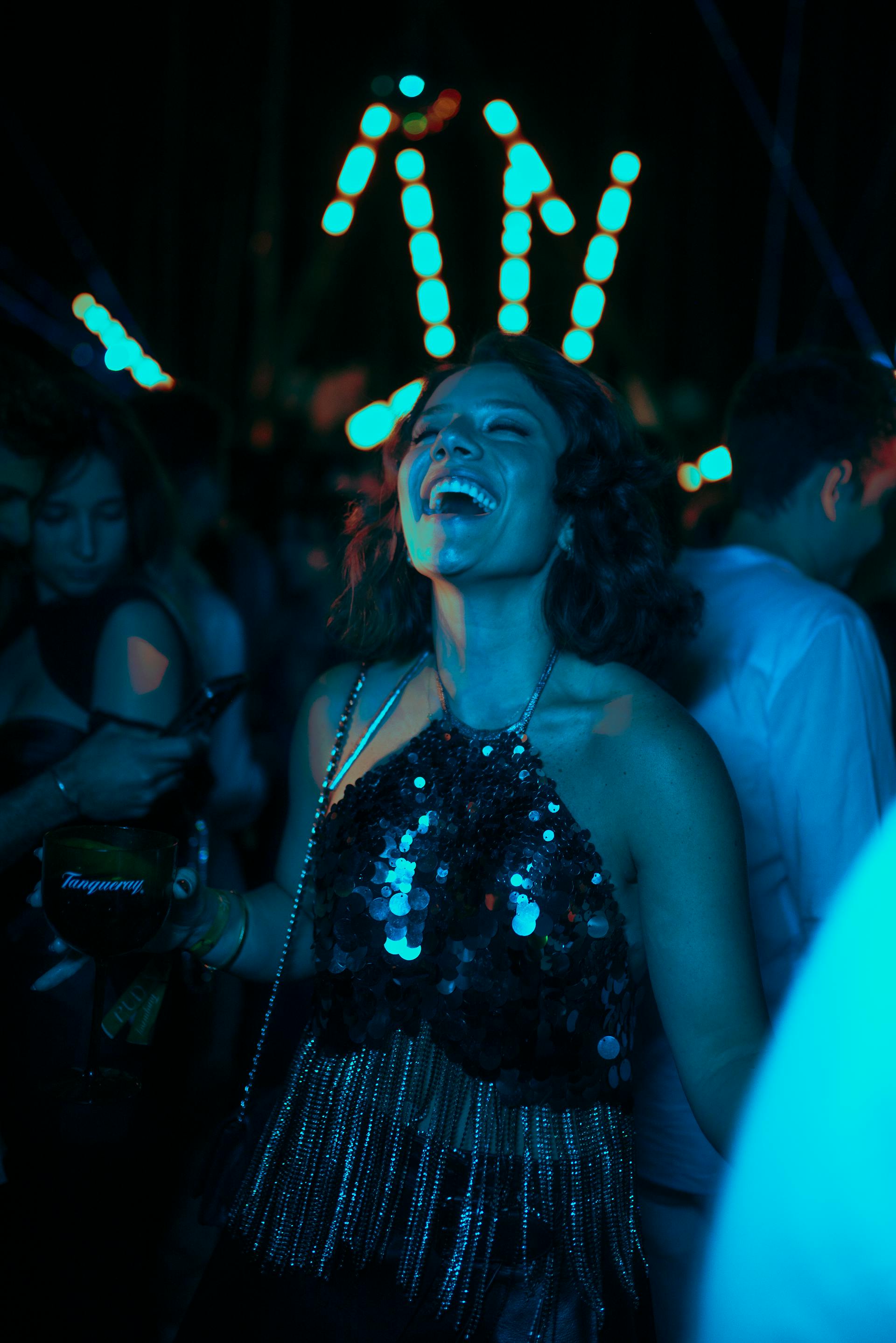 A woman laughing at a party | Source: Pexels