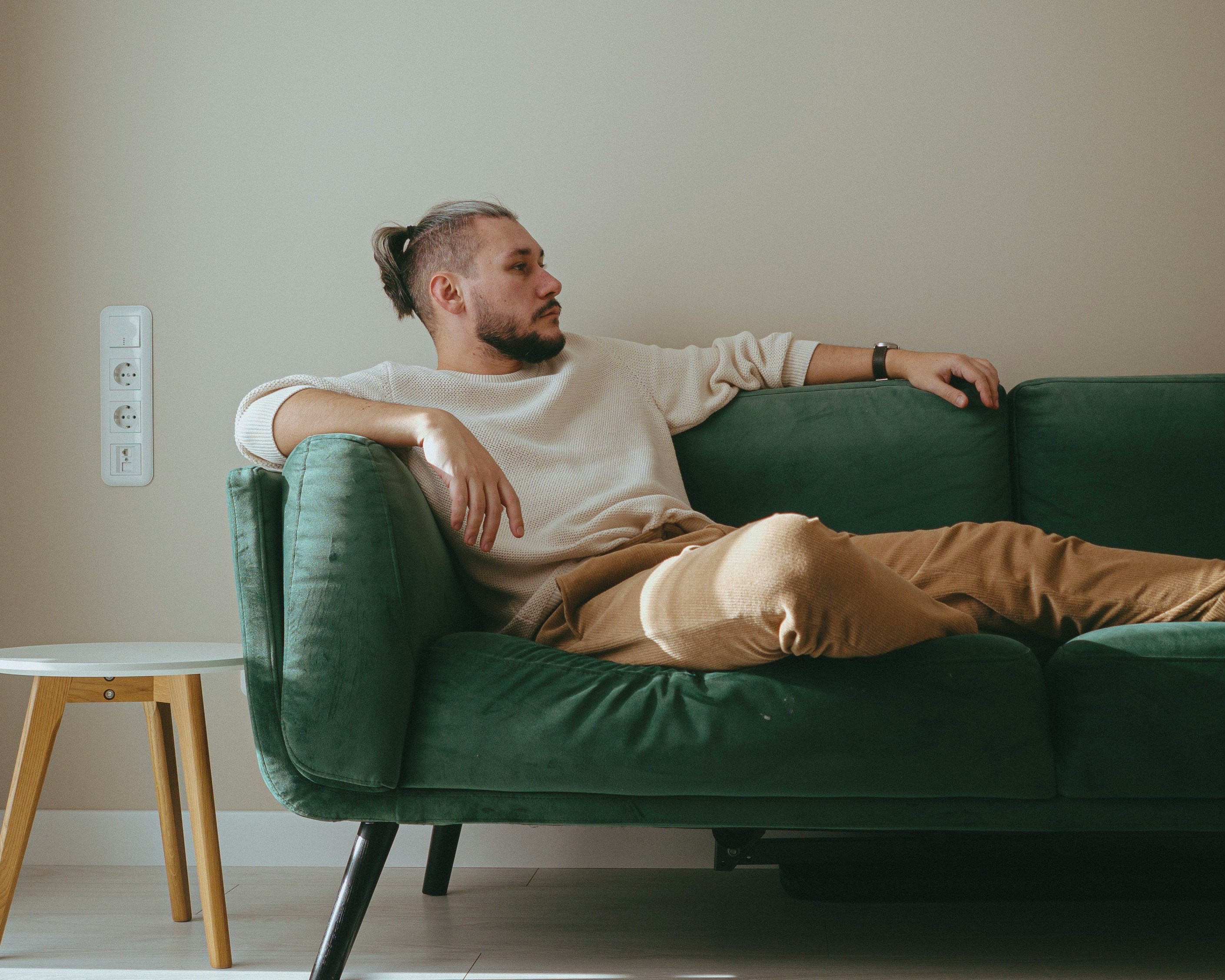 My MIL Demanded I Leave My Own Home During the Birthday Party I Organized for Her – She Didn't Know How Big a Mistake That Was 24 A man sitting on a couch | Source: Unsplash