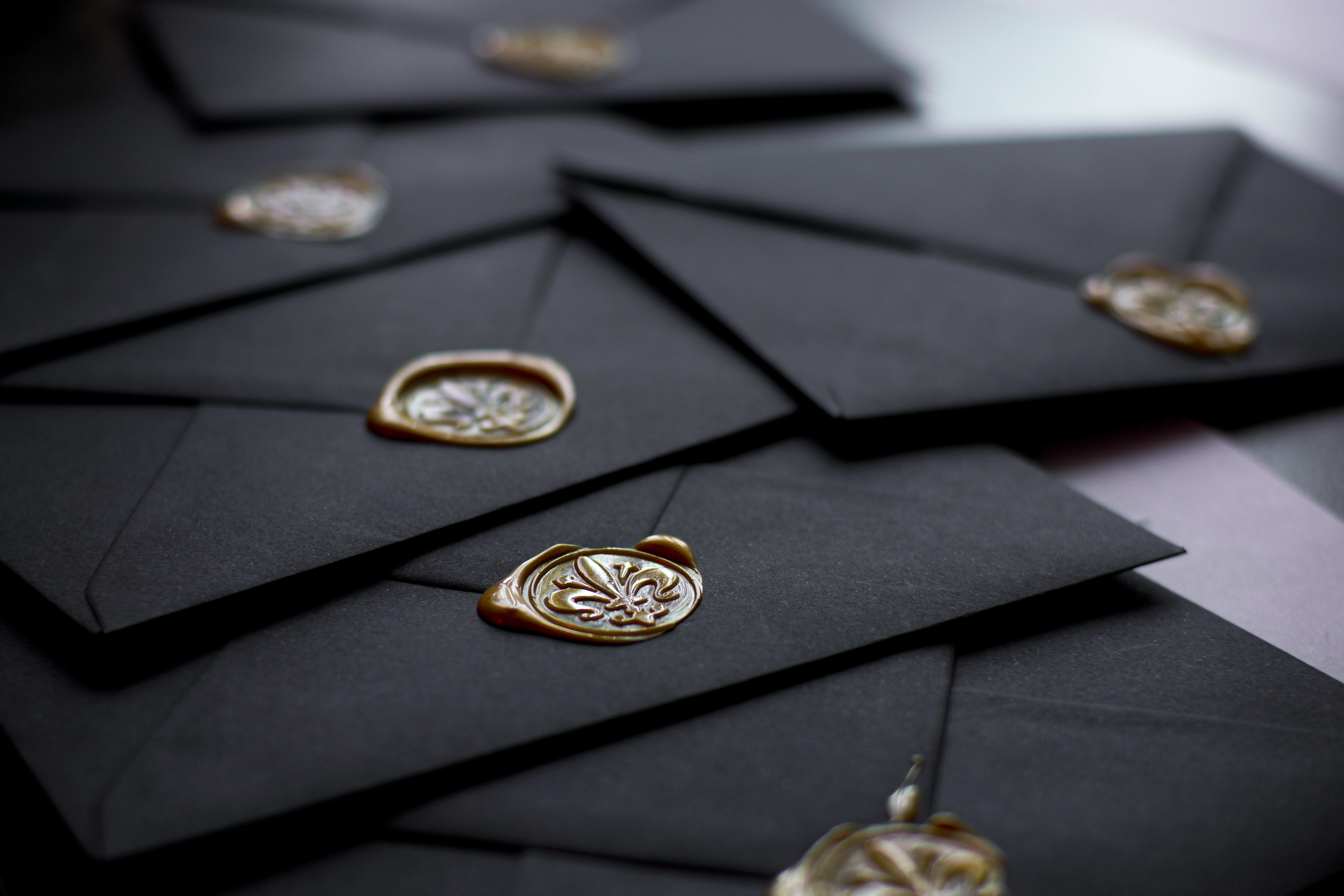 Black wedding invitations with wax stamps | Source: Pexels