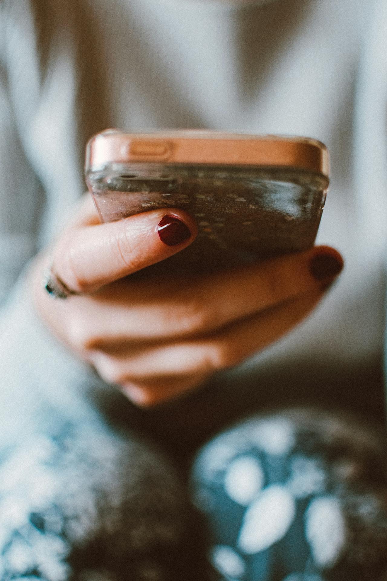 A woman holding a phone | Source: Pexels