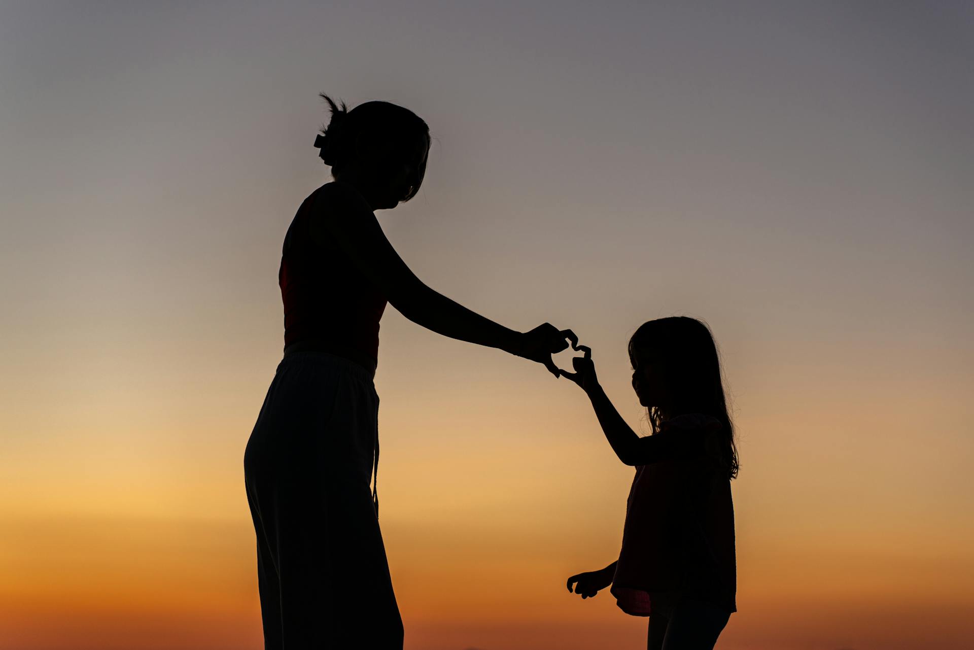 My Daughter Told Me Not to Visit Her Family Again — Days Later, She Was at My Door Begging 16 Silhouette of a mother and daughter making a hand heart gesture | Source: Pexels