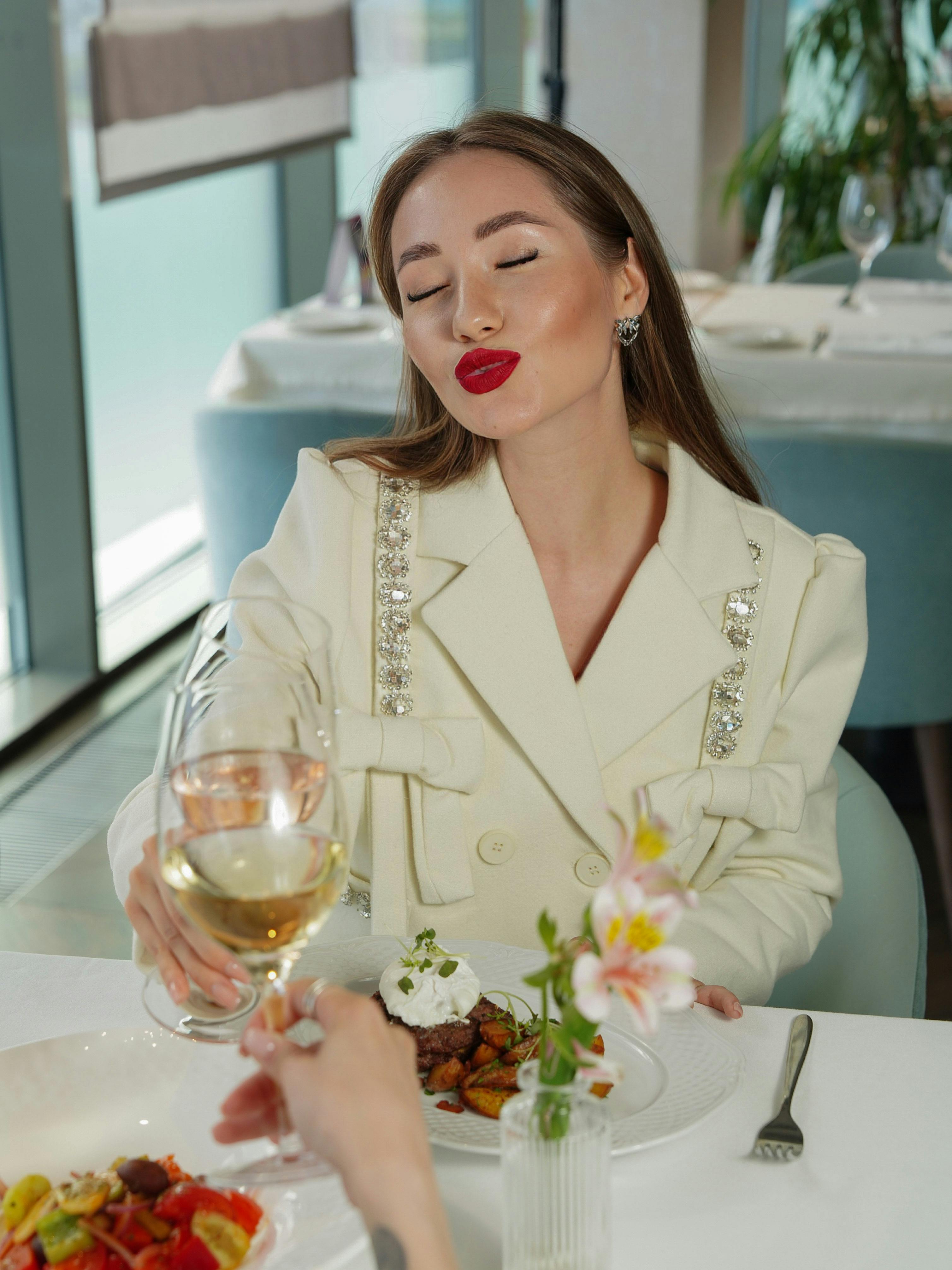 A well-dressed woman dining at a restaurant | Source: Pexels