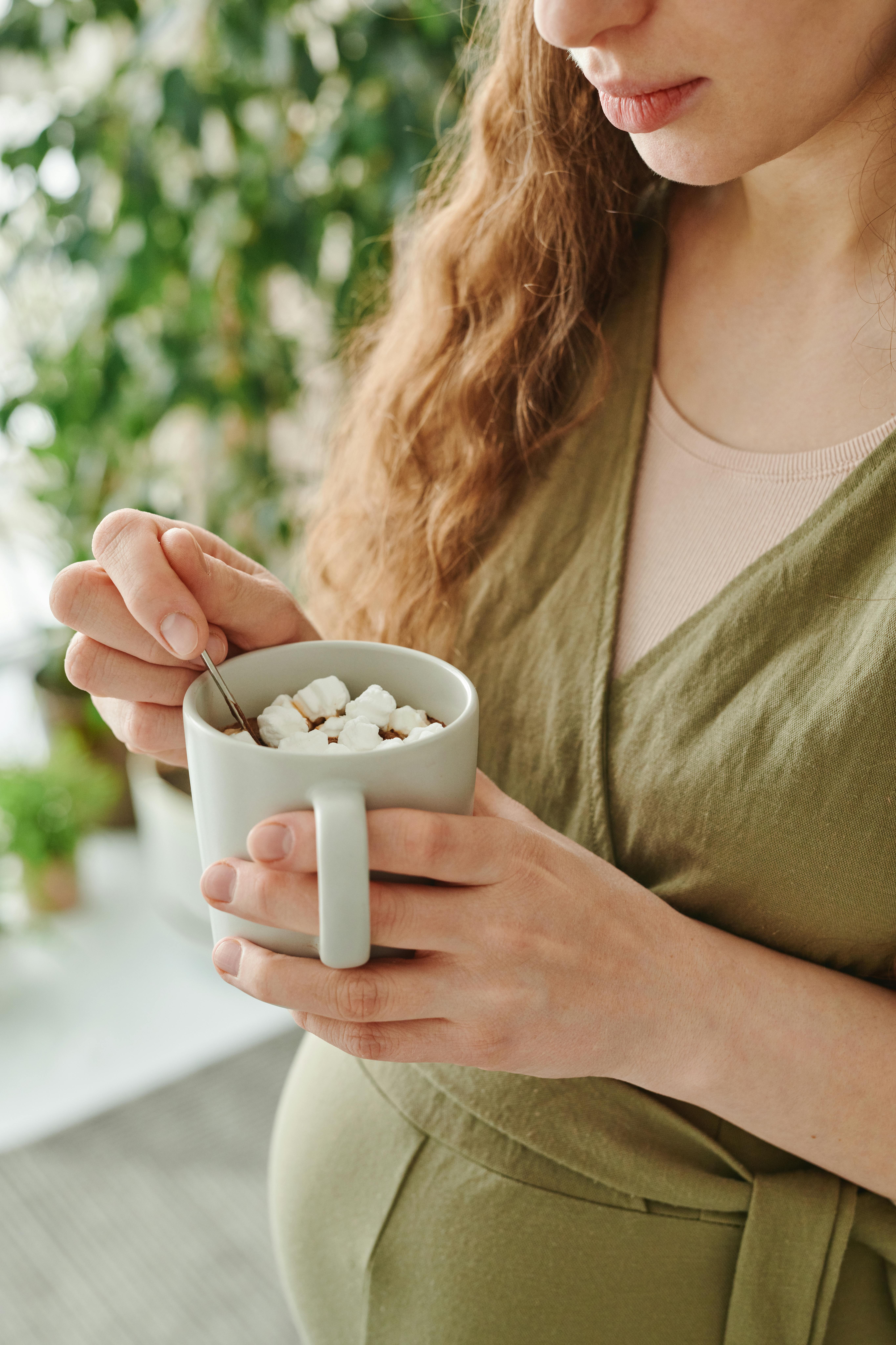 A woman holding a cup of hot chocolate | Source: Pexels