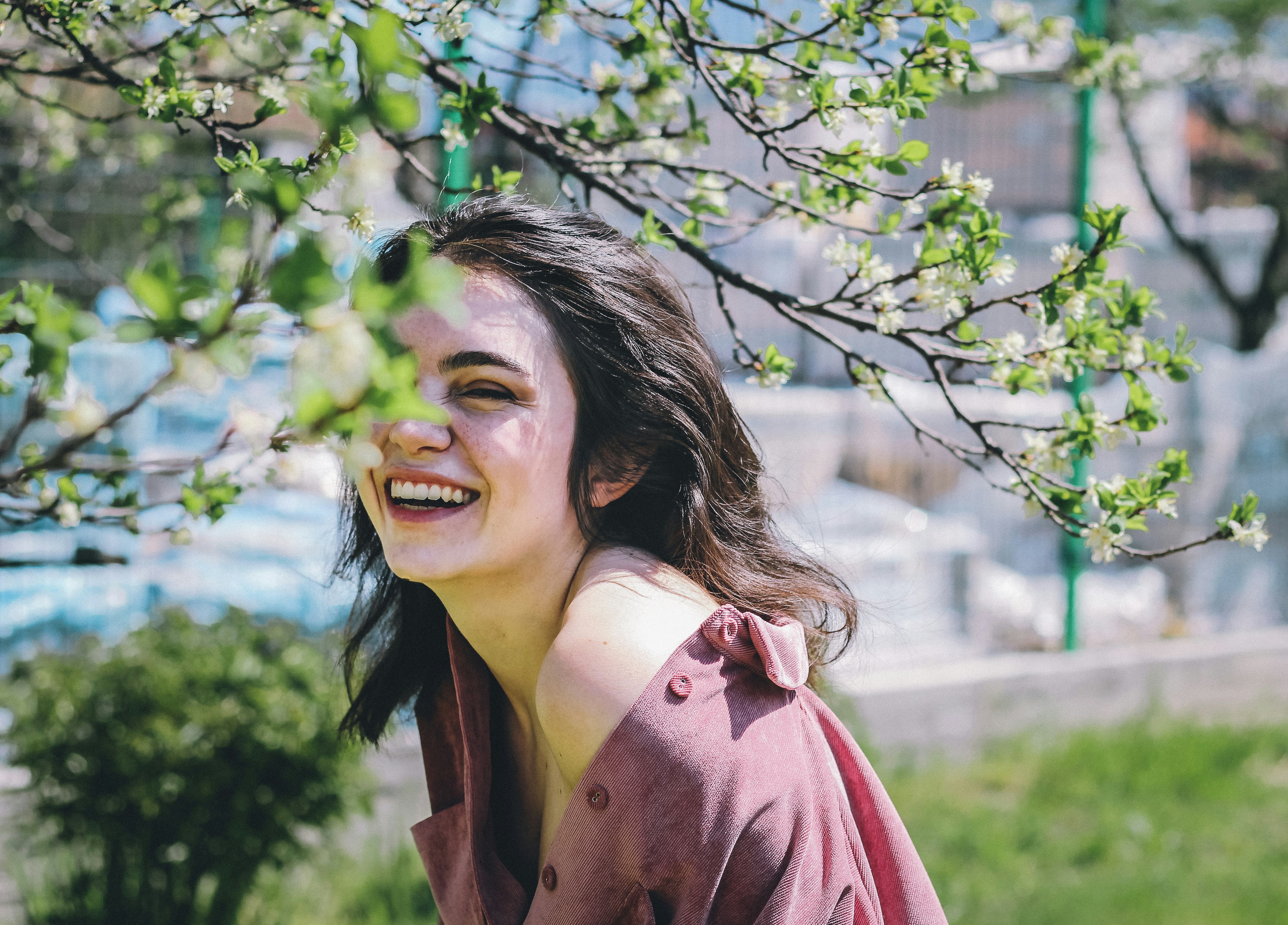 A smiling young woman standing outside | Source: Unsplash