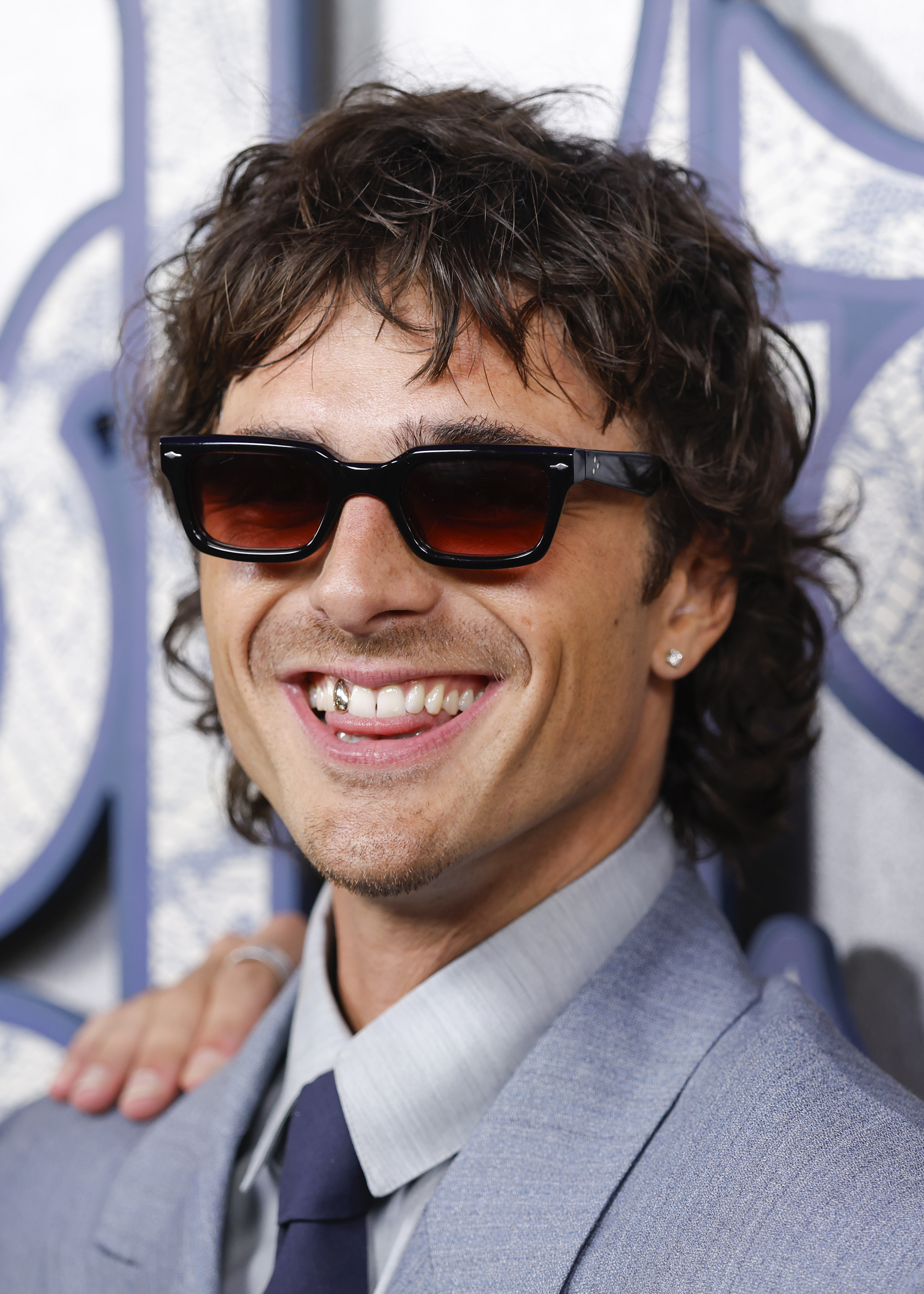 Jacob Elordi flashing a gold tooth during the Sydney premiere of "Wuthering Heights" at State Theatre on February 12, 2026 | Source: Getty Images