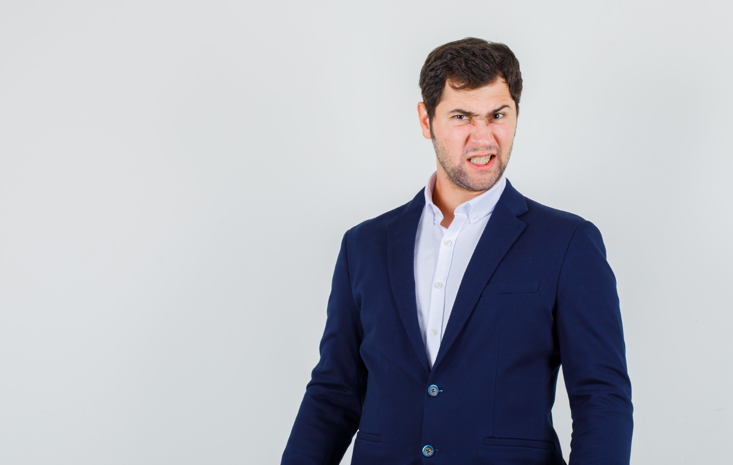 An angry man clenching his teeth | Source: Freepik