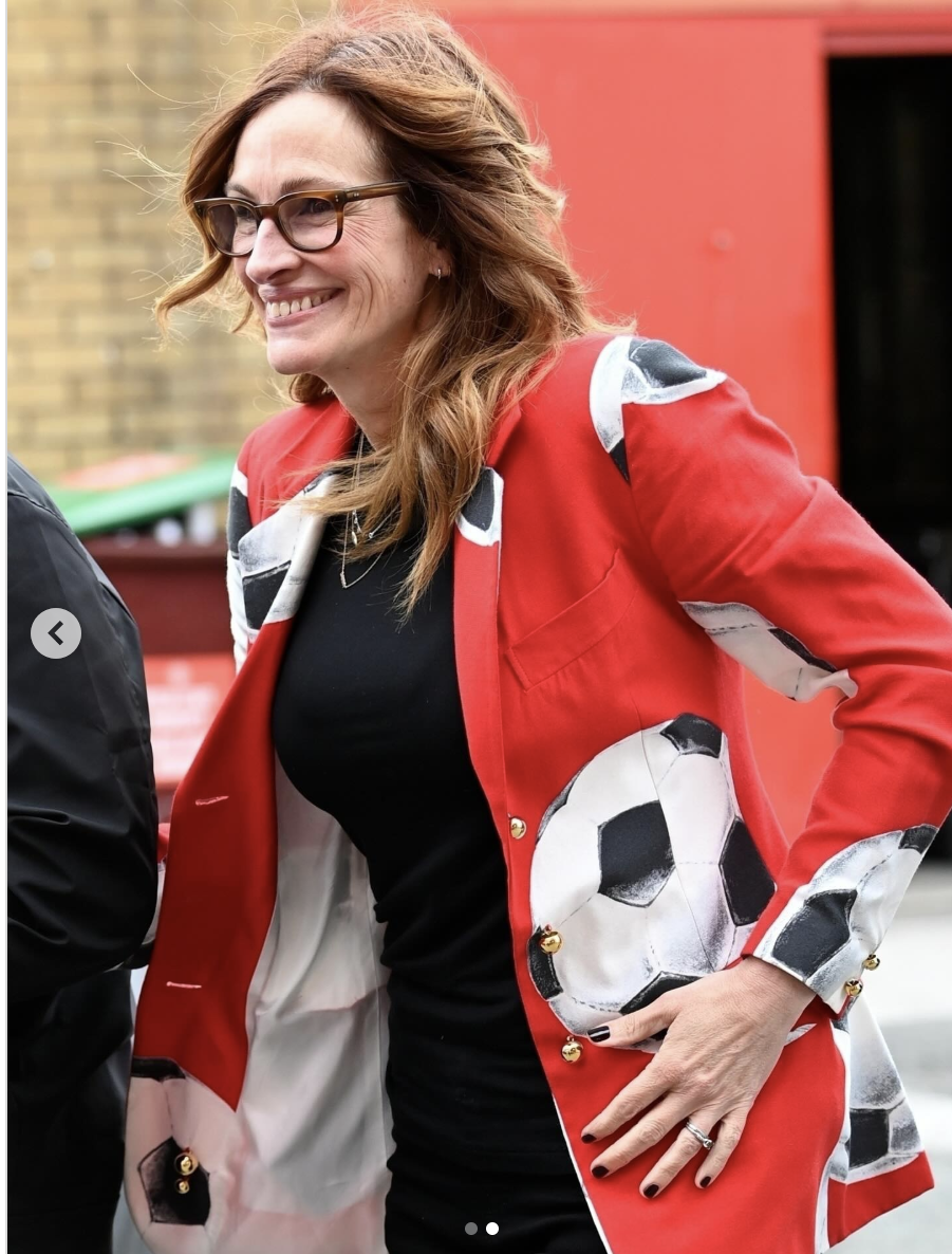 Julia Roberts wears a red soccer-themed coat on June 15, 2025 in Manchester, England | Source: Instagram/justjared