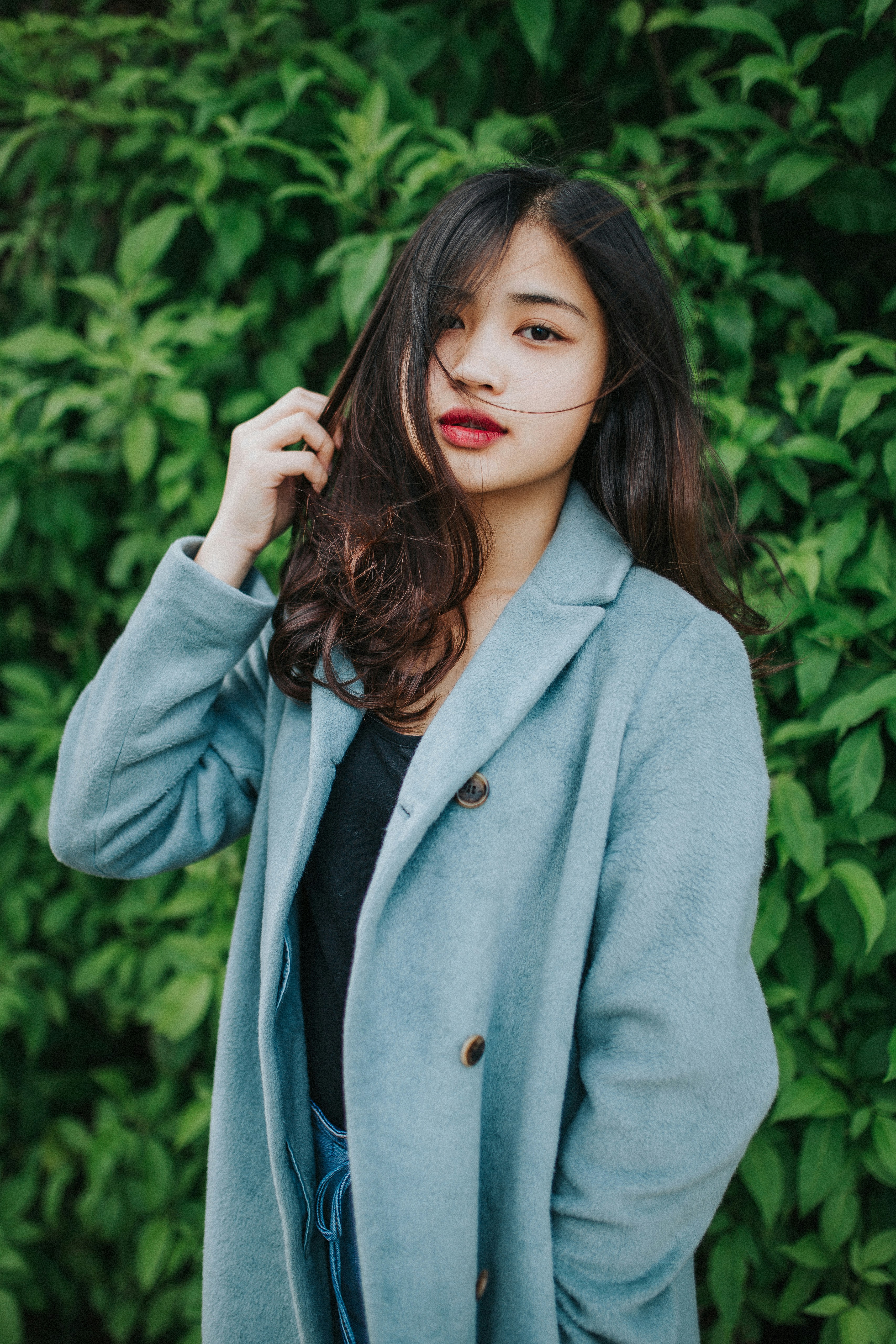 A woman standing outside wearing a blue coat | Source: Unsplash