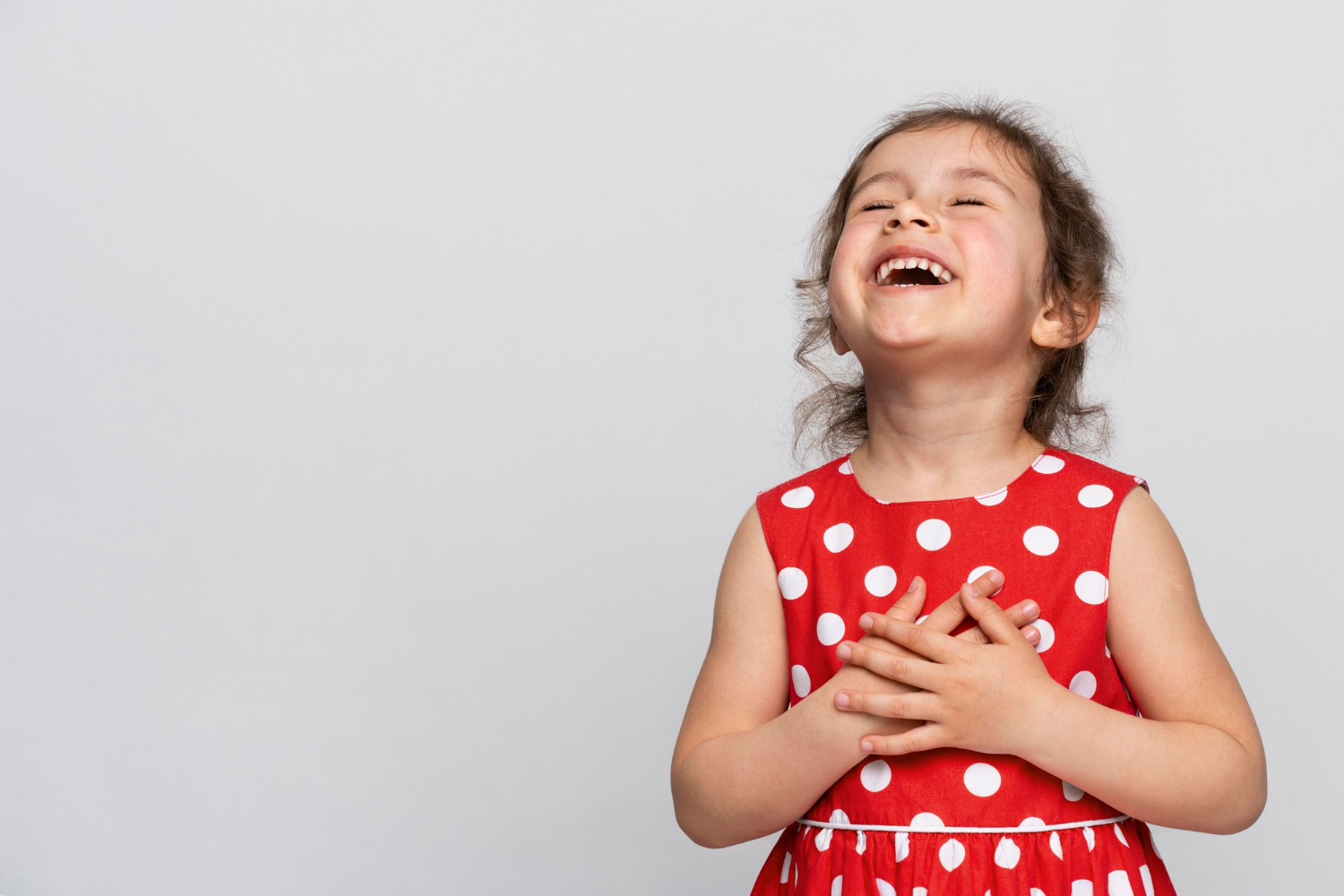 A little girl laughing | Source: Freepik