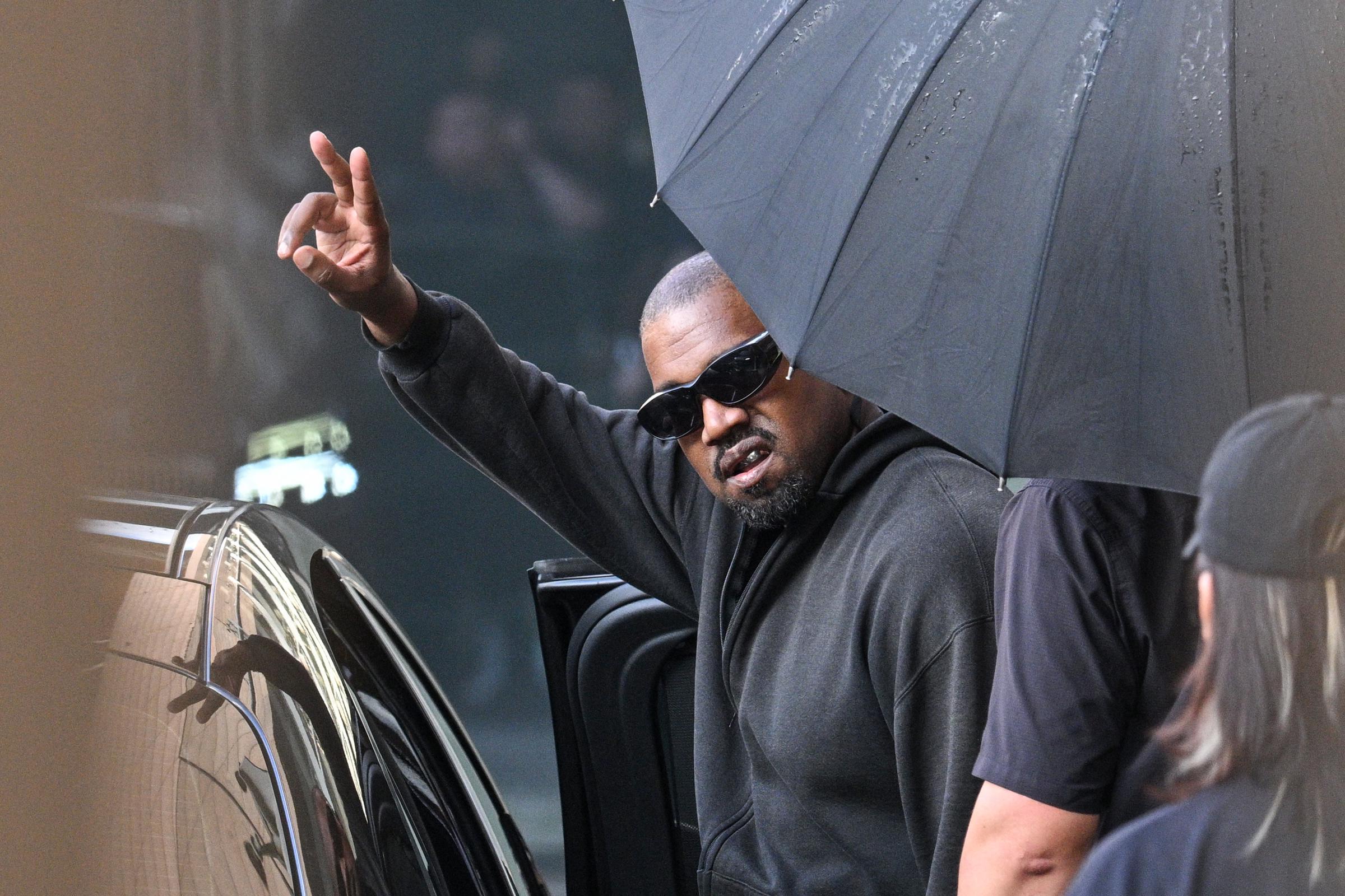 Kanye West gestures upon arriving at Shanghai Pudong International Airport on July 11, 2025. | Source: Getty Images